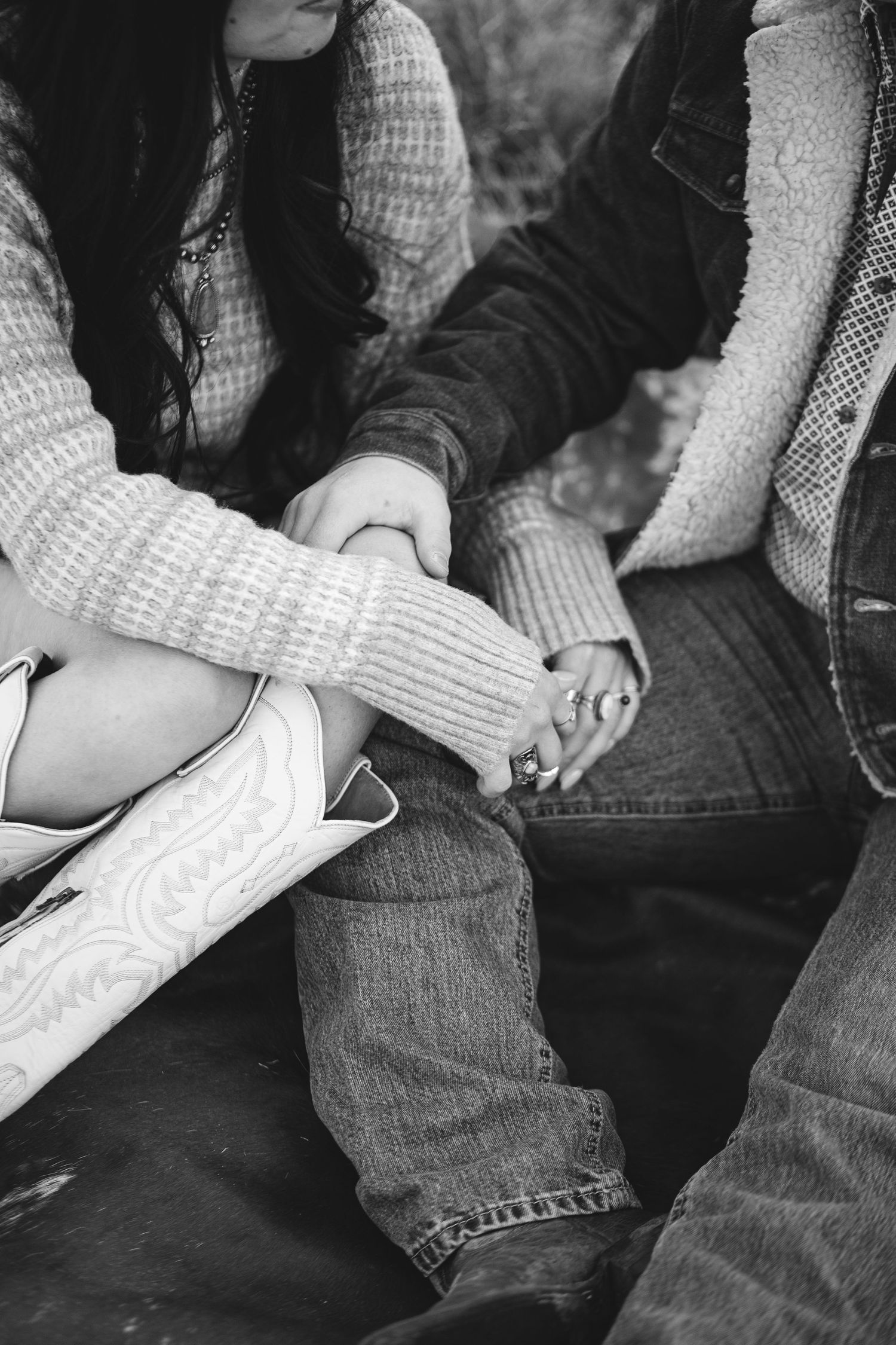An unclose photo of a couple sitting down and enjoying each others company in this black and white photo taken in Eagle Idaho