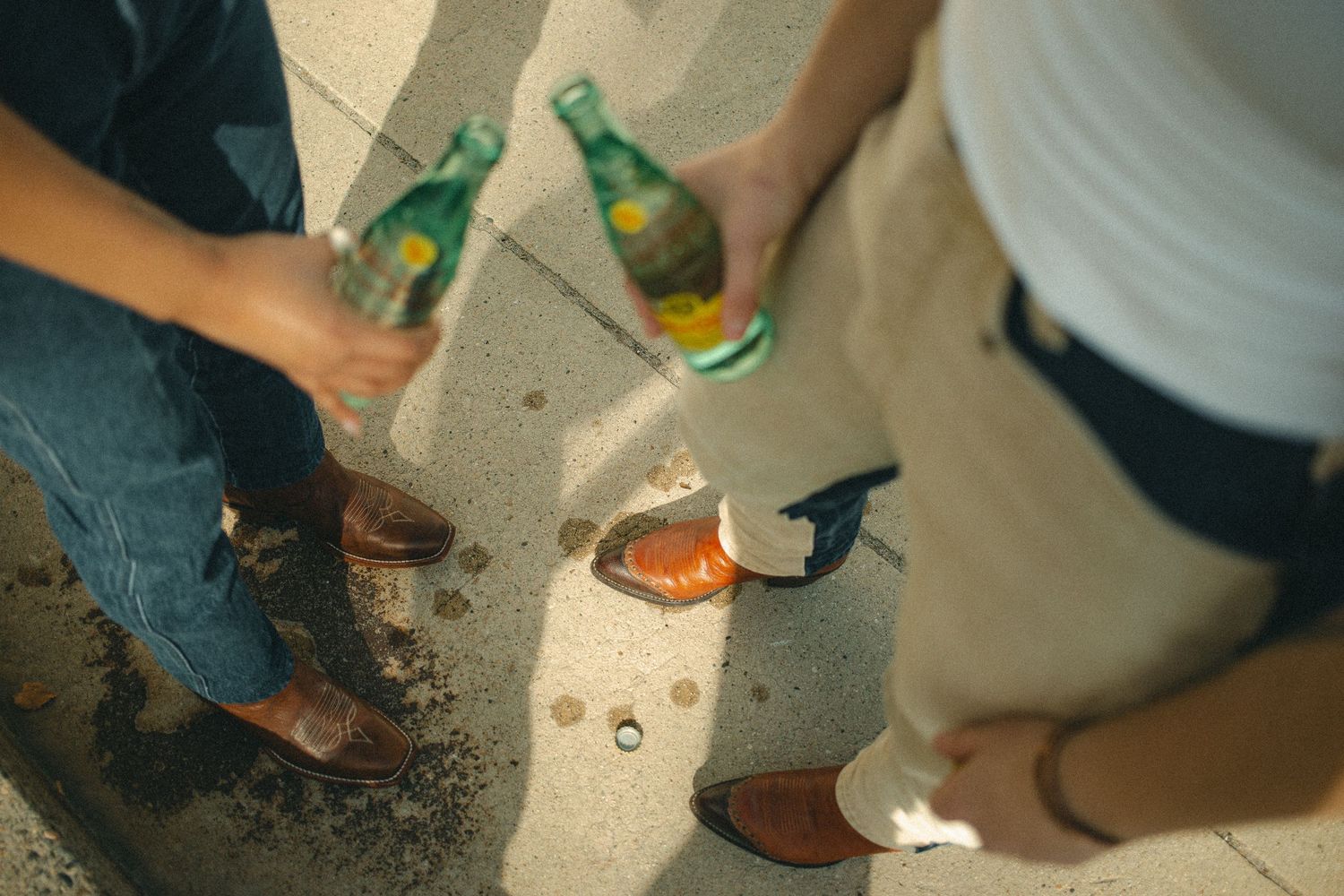 A close-up view of cowboy boots standing in the hot summer days while these two friends enjoy a cold beverage in Emmett Idaho