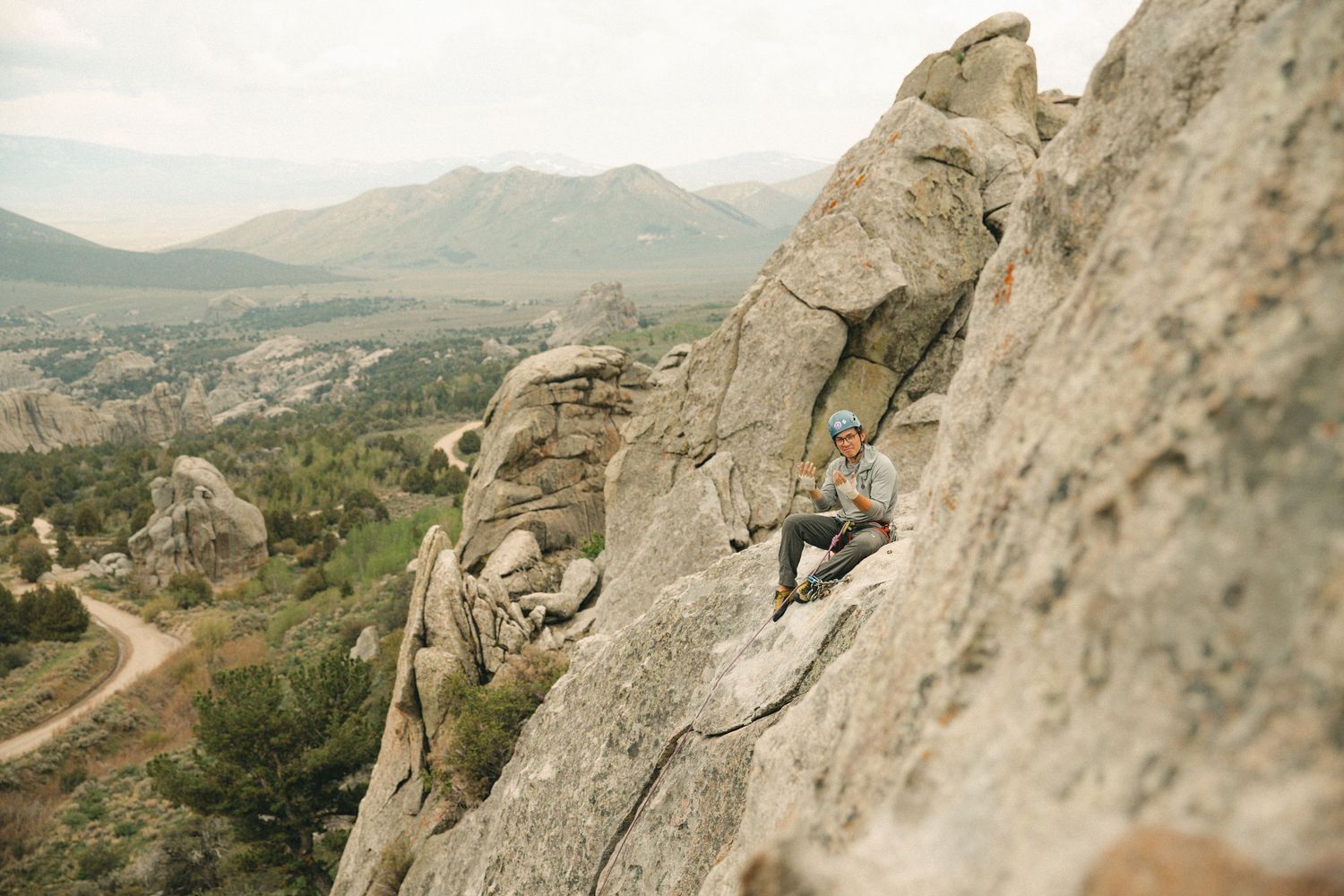 Scenic mountain landscape with winding roads and rugged rock formations stretching into the distance.
