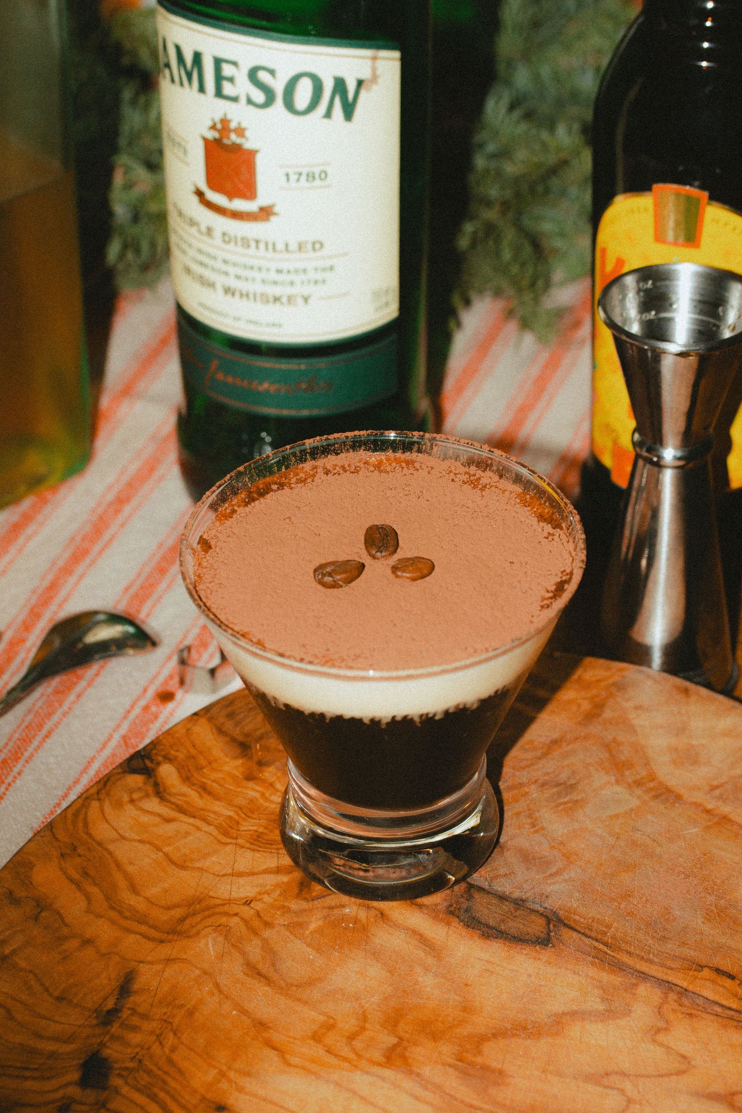 A dreamy film style photo showcases a creamy espresso martini in a home setting