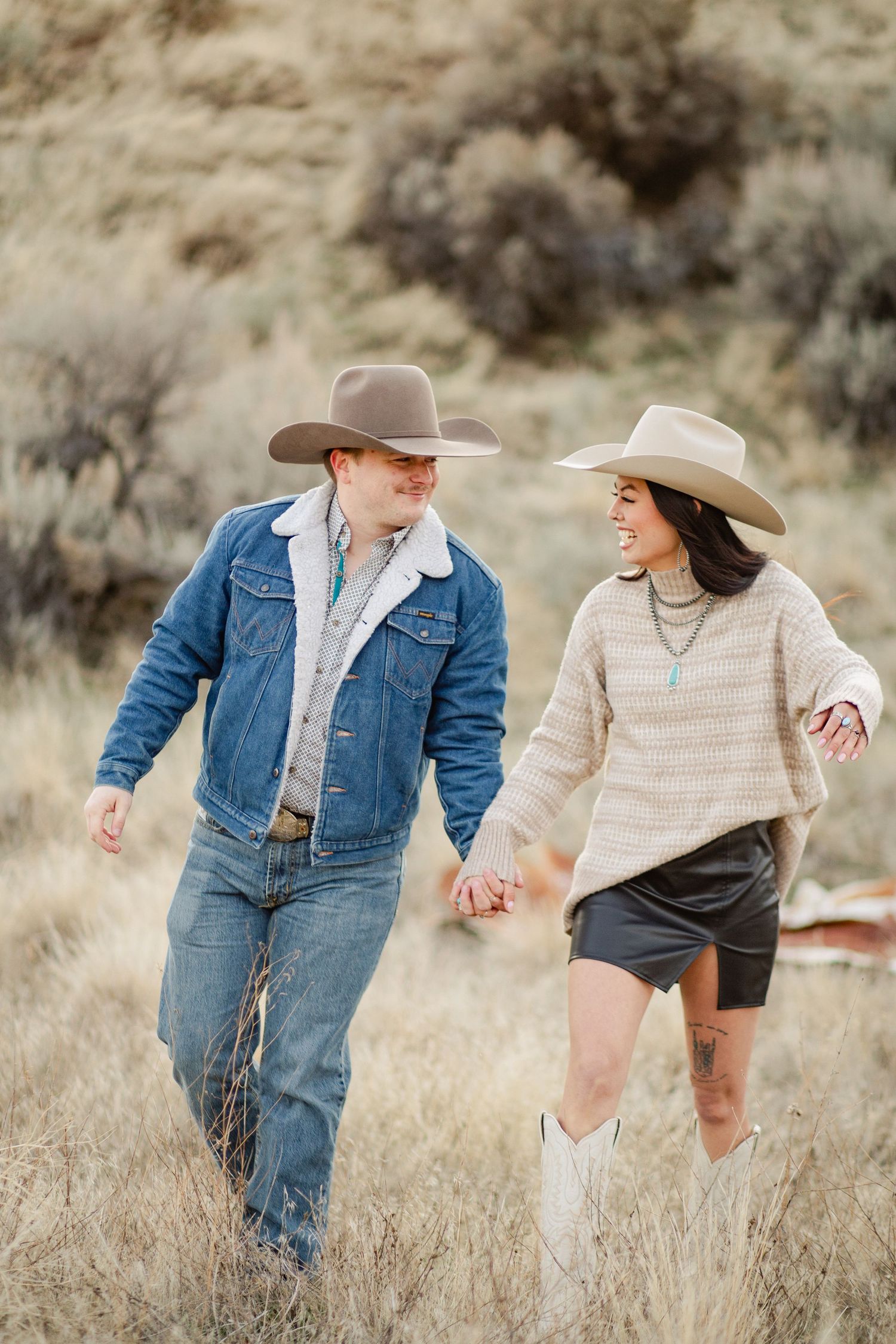 Couple walks together in the eagle Idaho foothills as they get their engagement photos taken by Stoked Media