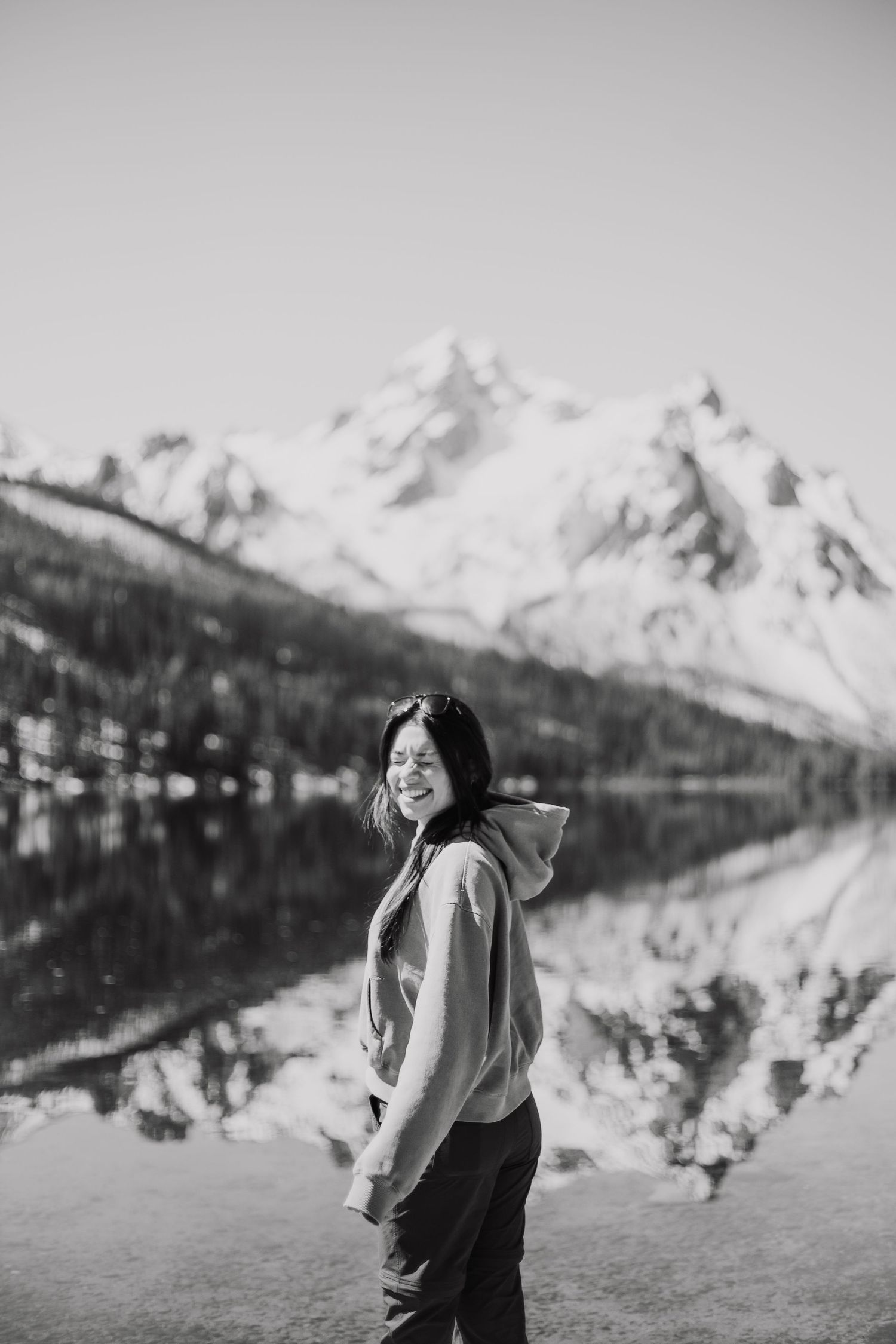 Black and white photo shows stoked media owner standing in front of a vast mountain in Stanley Idaho