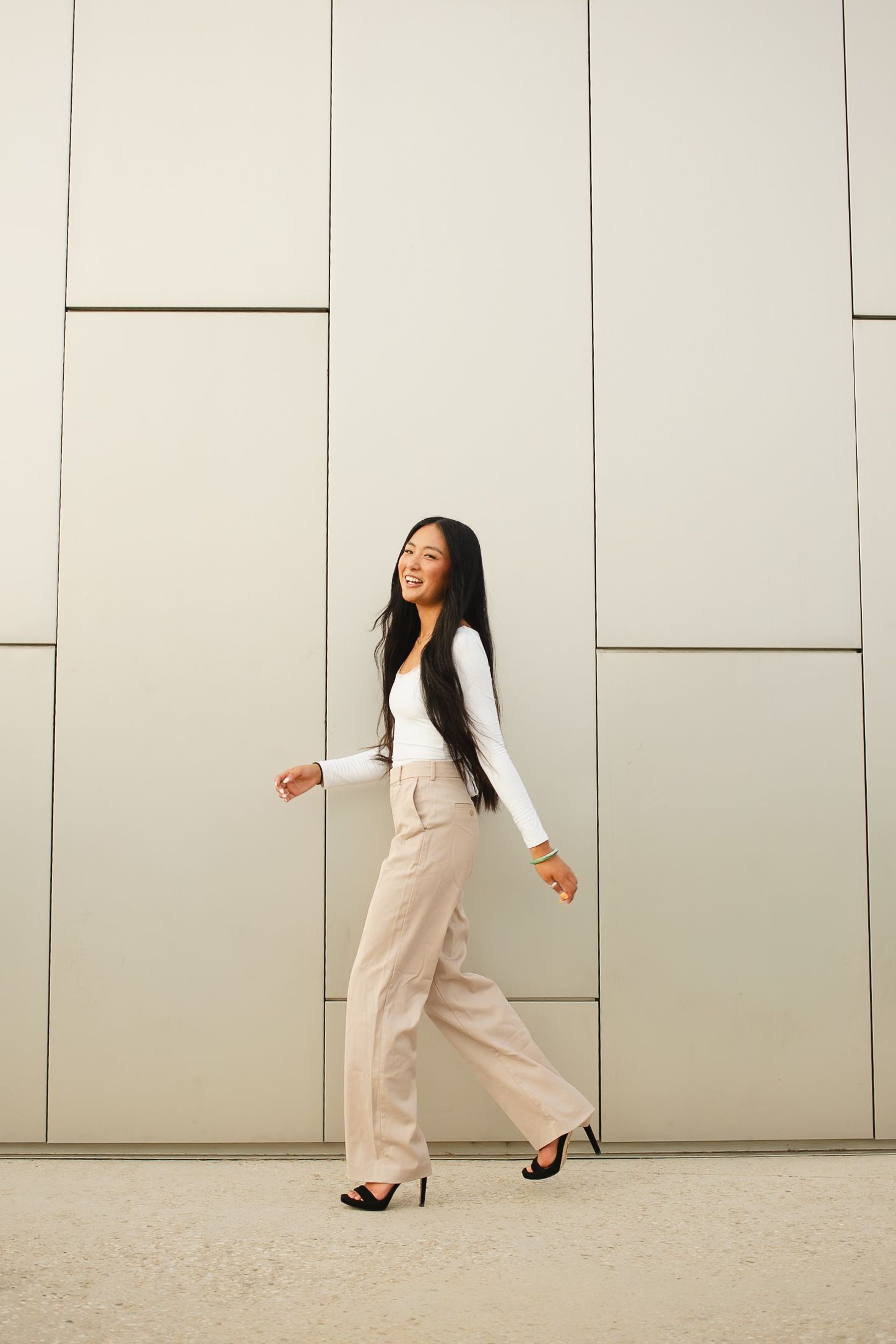 This warm photo shows a girl as she walks across the the frame in this urban setting located in Boise Idaho