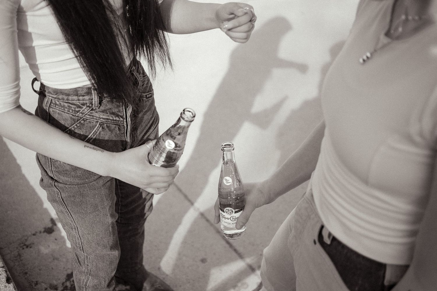 A black and white photo shows two friends enjoying a bubbly drink while they keep each other company in Emmett Idaho