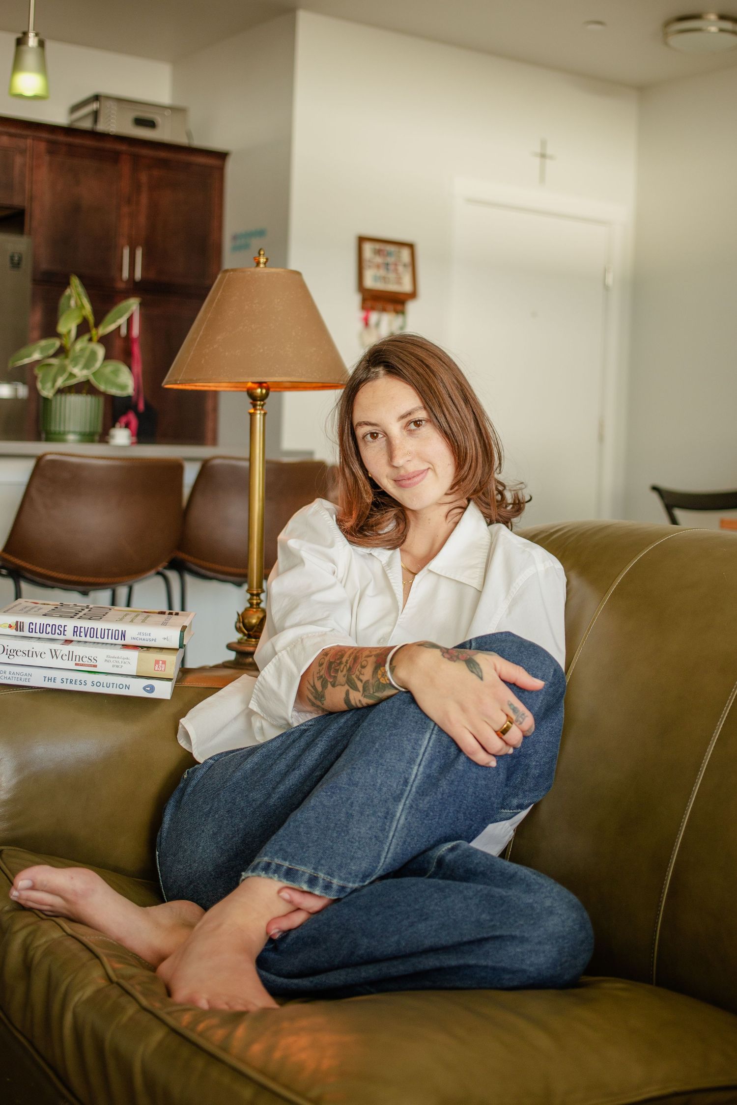 Young girl poses in living room for a cozy portrait session based in boise Idaho