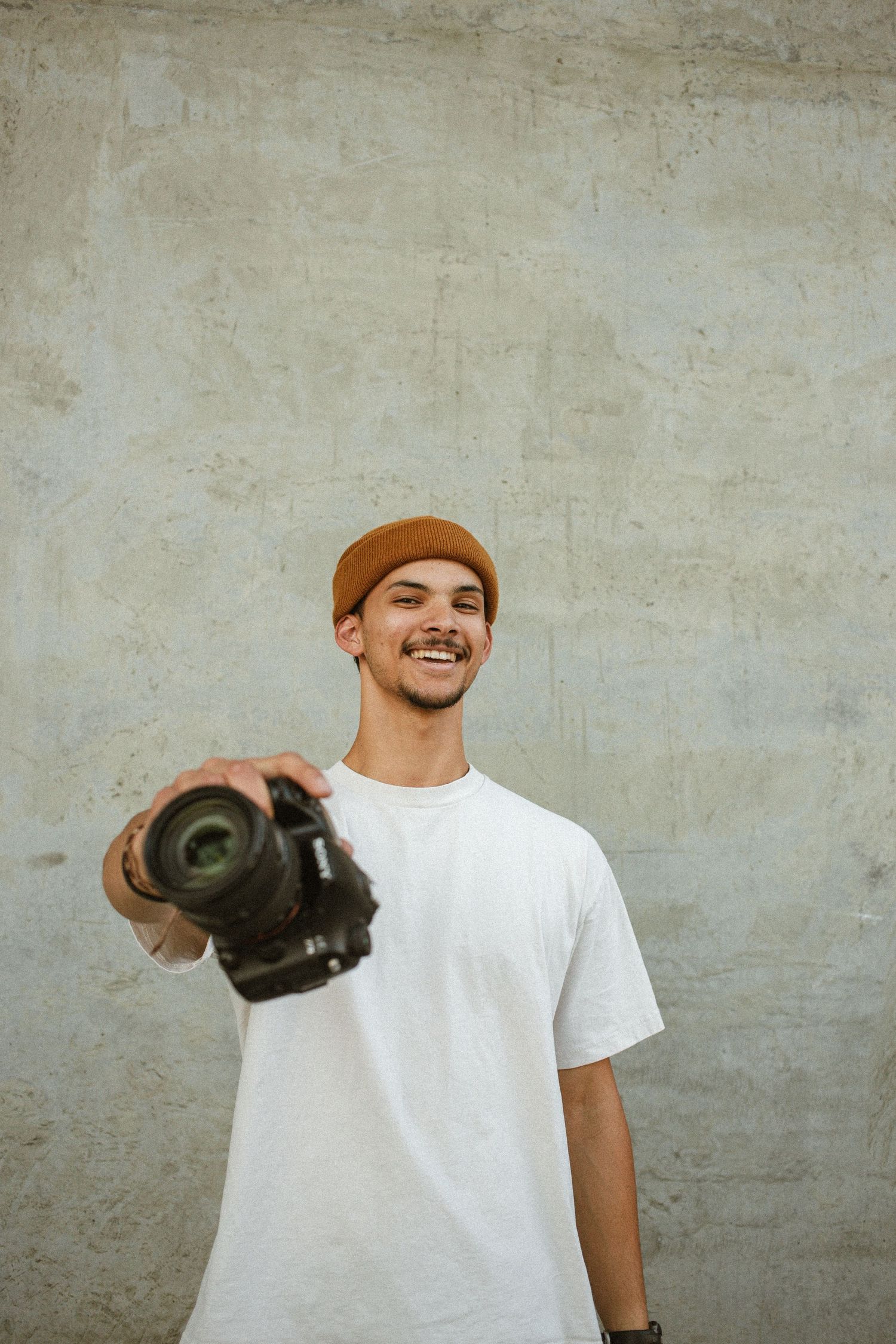 Photographer gets his photos taken in an urban setting as he shows off his camera in Boise Idaho