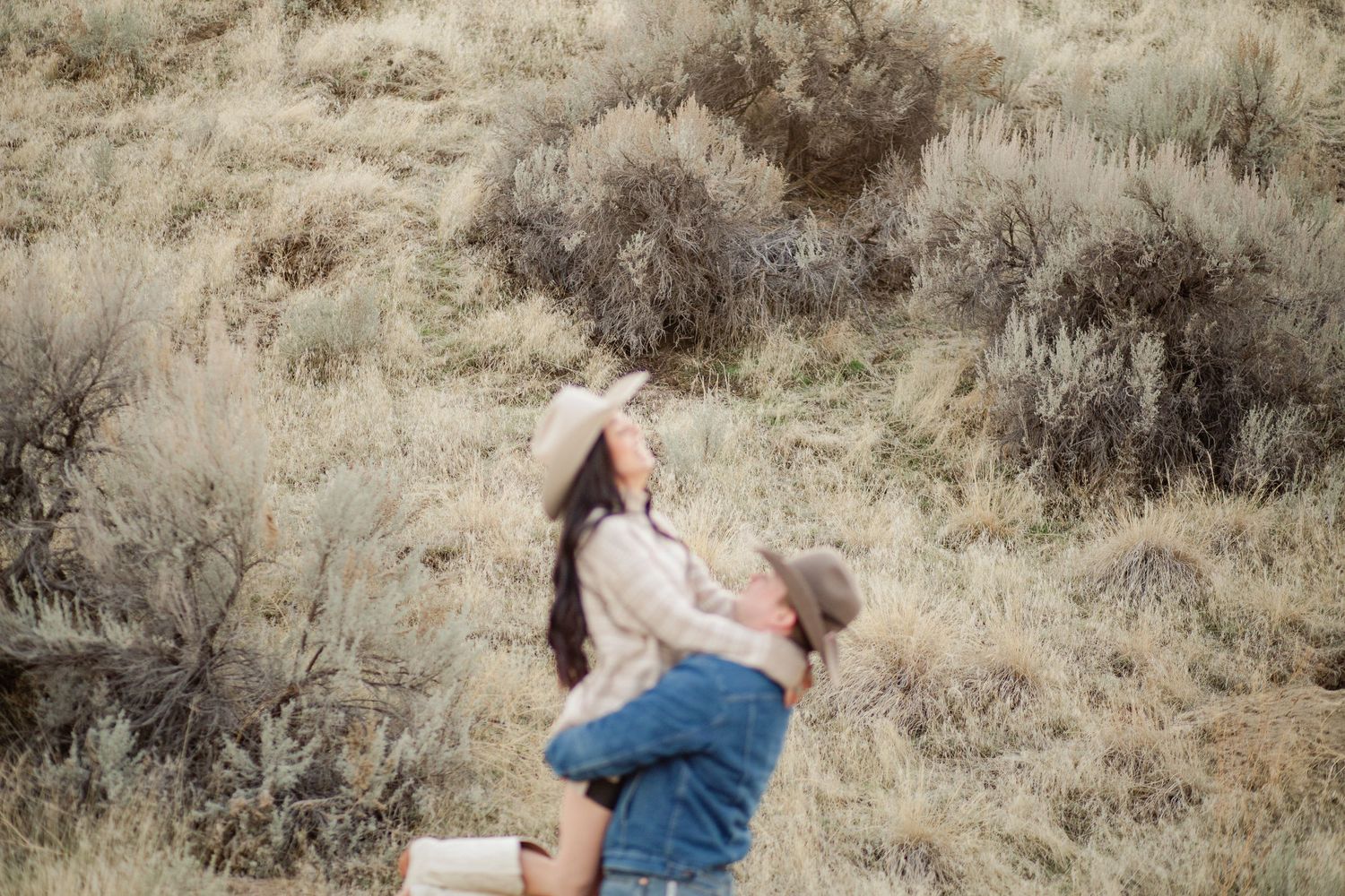 couple pose in the boise foot hills for an engagement photoshoot
