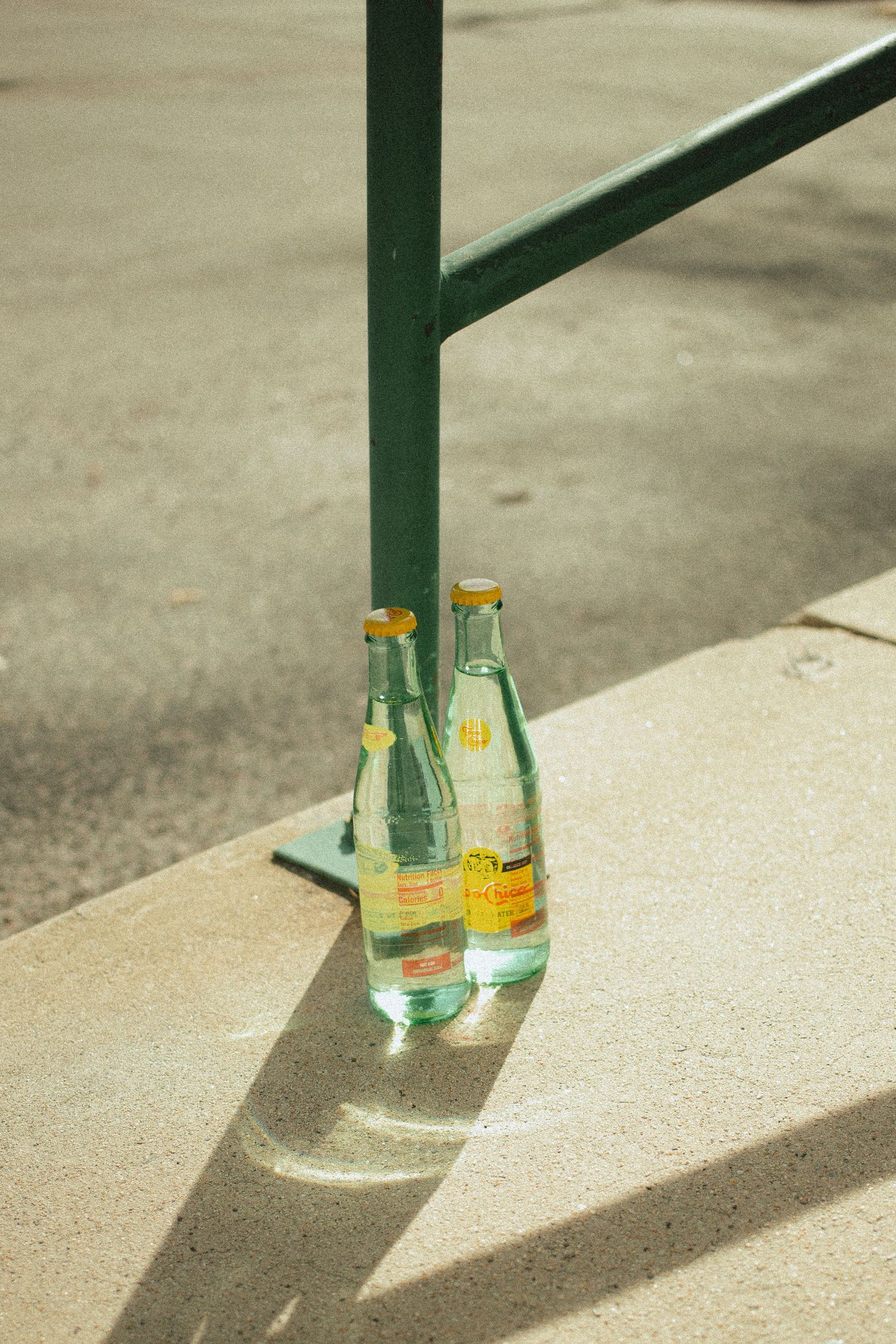 an urban setting of concrete shows a couple of crisp topo chicos in the hot summer sun in Emmett Idaho