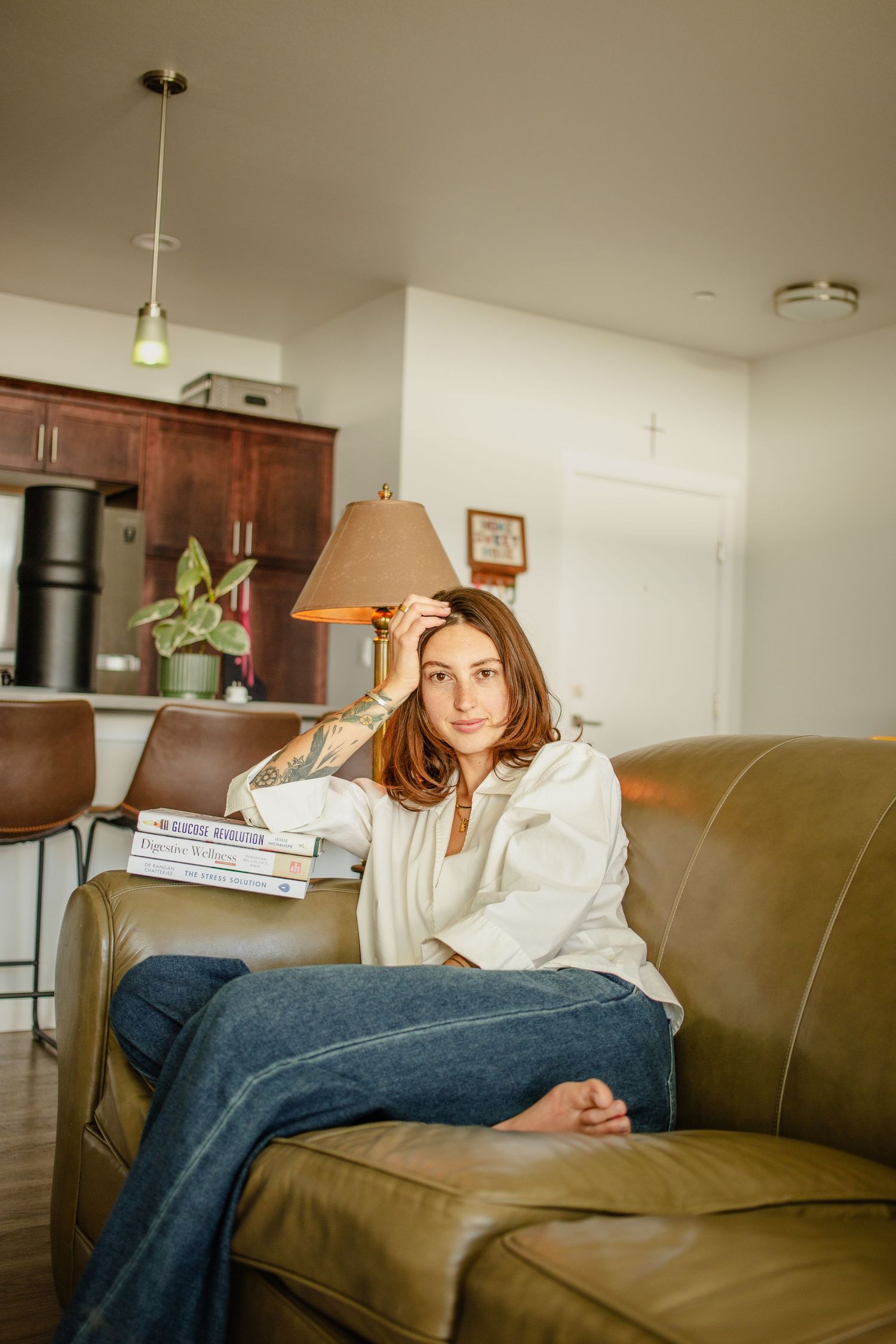 This cozy image shows a girl as she poses on her couch for some in home portraits based in Eagle Idaho