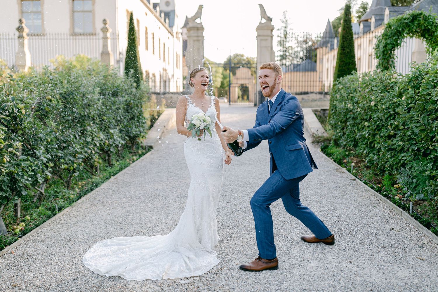 Playful wedding couple photos on a cobblestone path showing movement and joy.