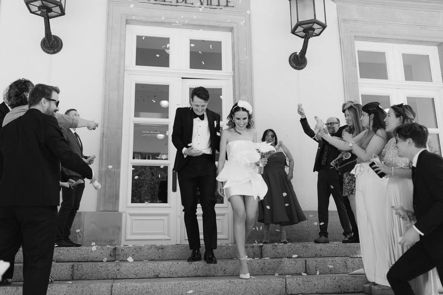 Black and white wedding reception photos capturing guests dancing and celebrating.