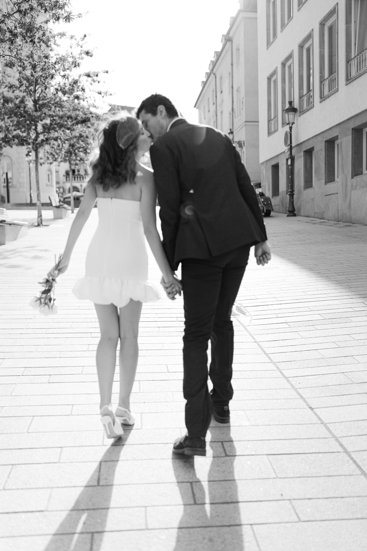 Black and white photos of feet walking together on a stone pathway.