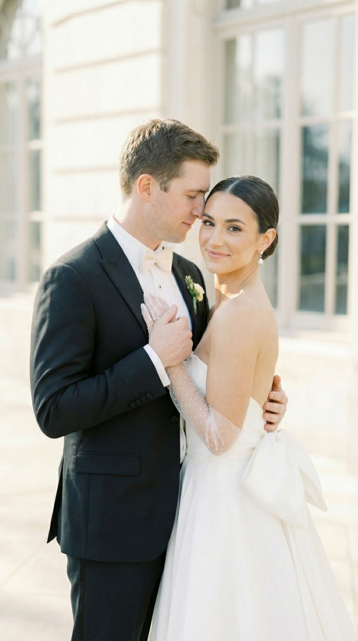 Intimate wedding portraits captured against a classic white building facade. Luxembourg wedding photographer