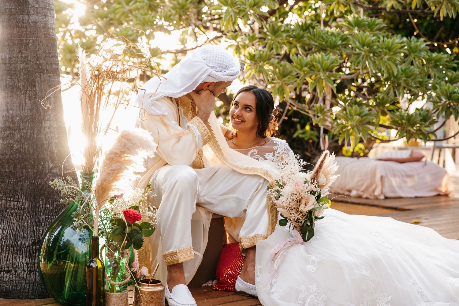 Golden hour wedding photography session among palm trees and natural scenery.