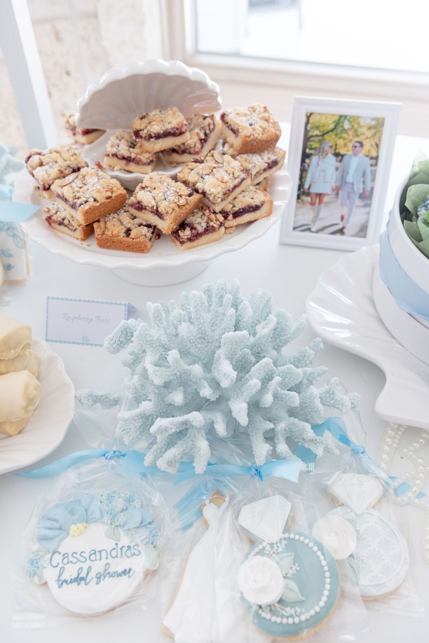 Treats on a sweet cart at a bridal shower by the sea.