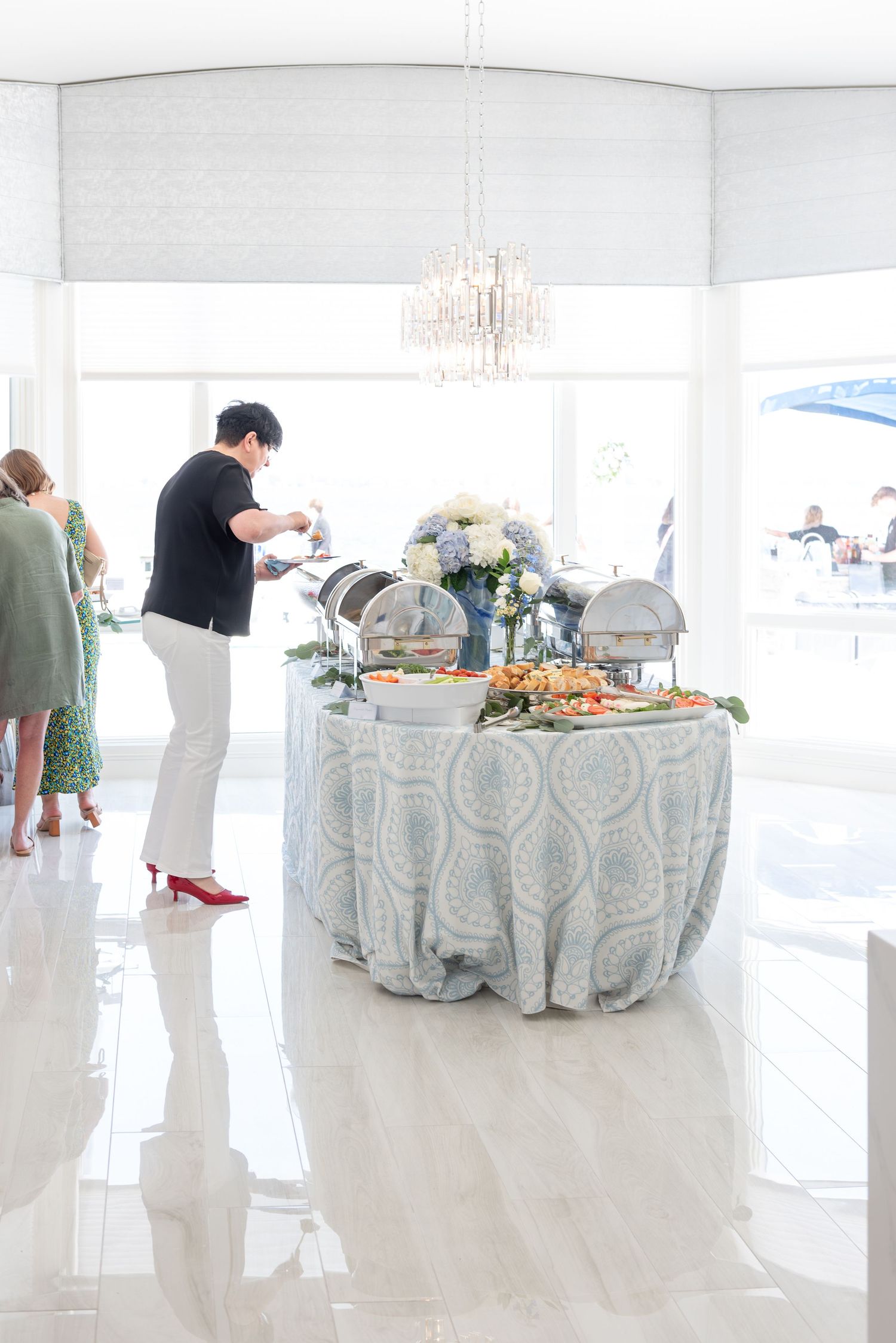 Guest enjoying the buffet at a bridal shower by the sea.