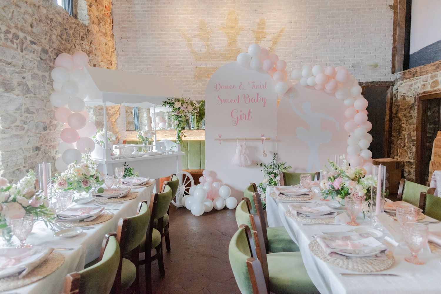 Elegant table settings with pink floral arrangements in a bright, modern restaurant dining room.