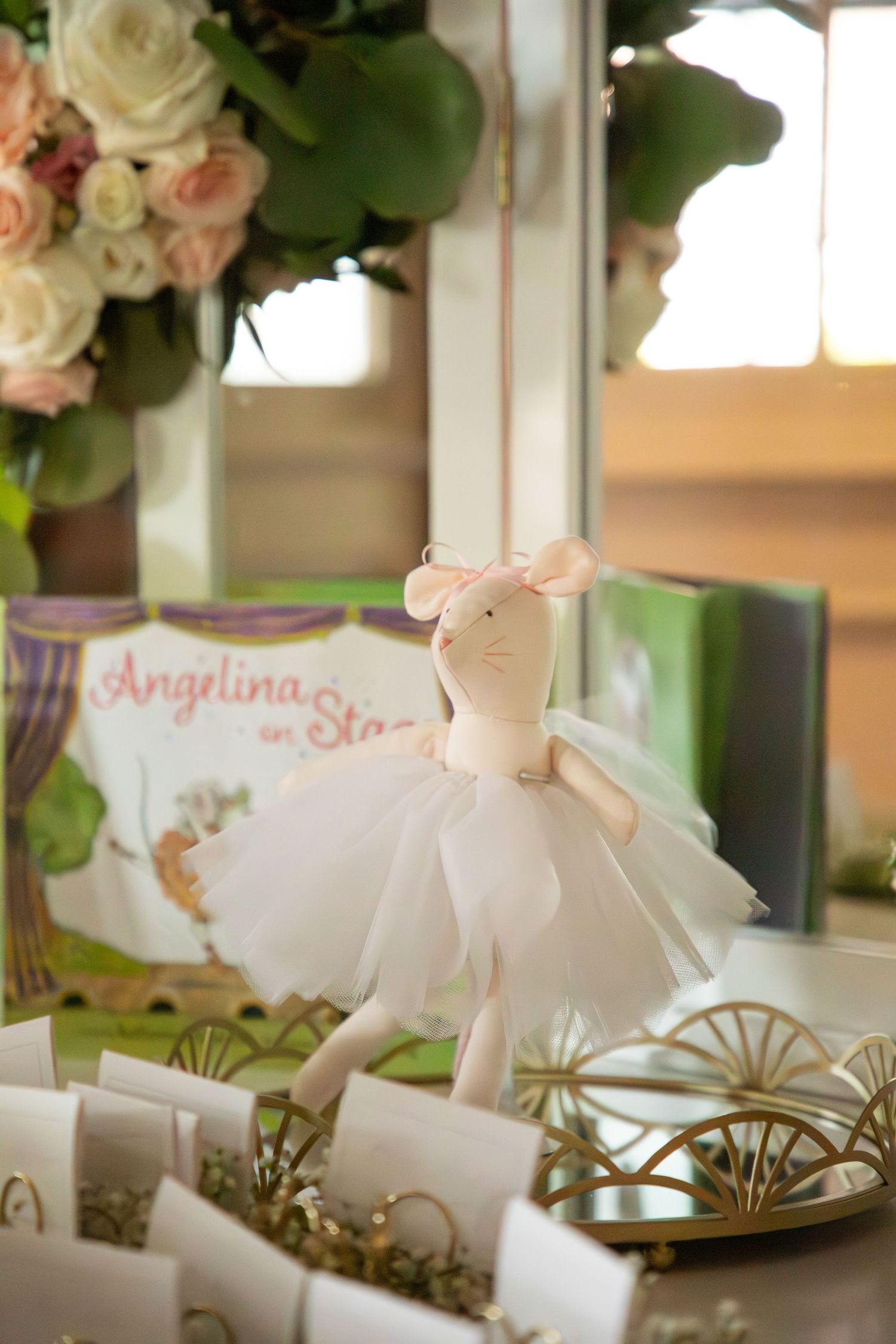 Plush bunny decoration arranged on a table with floral centerpieces and metallic accents.
