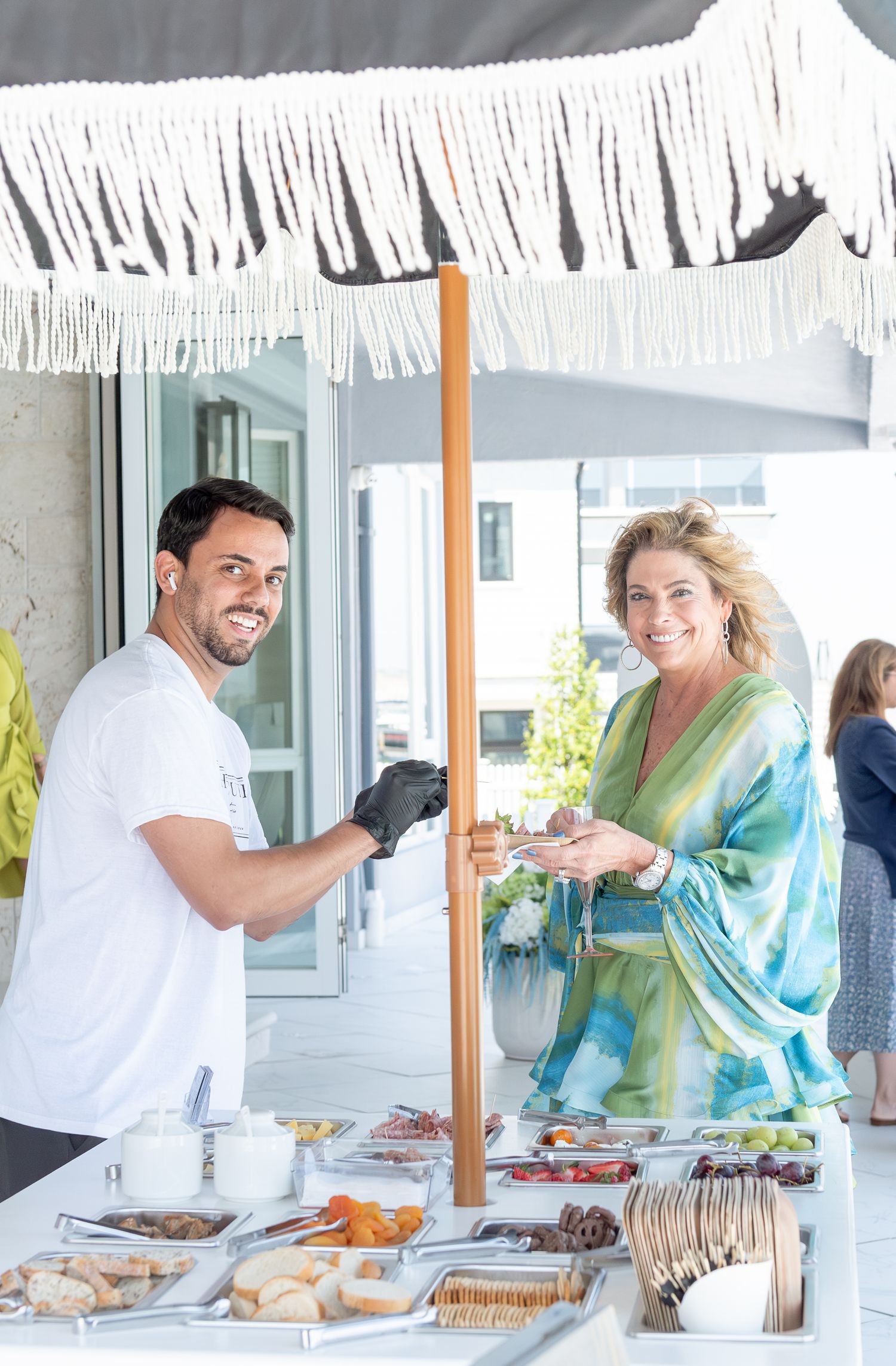 The mother of the bridge enjoying some charcuterie at a bridal shower by the sea.
