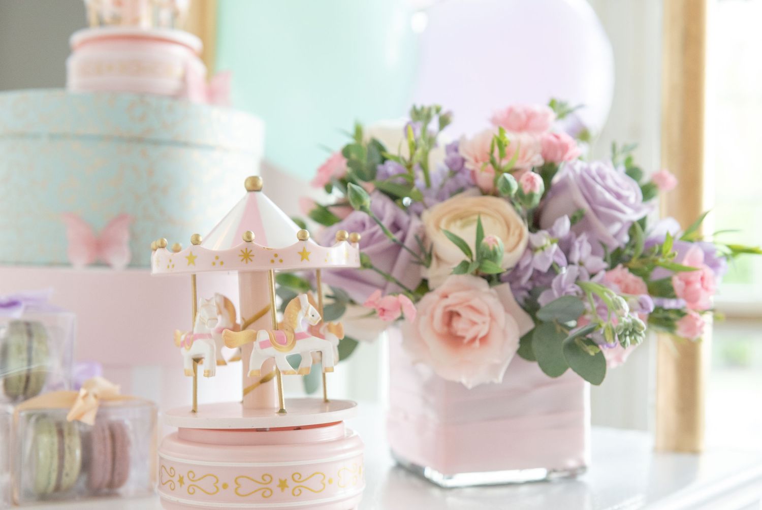 Pink and white wedding cakes with floral decorations and delicate pastel accents displayed in an elegant dessert setting.