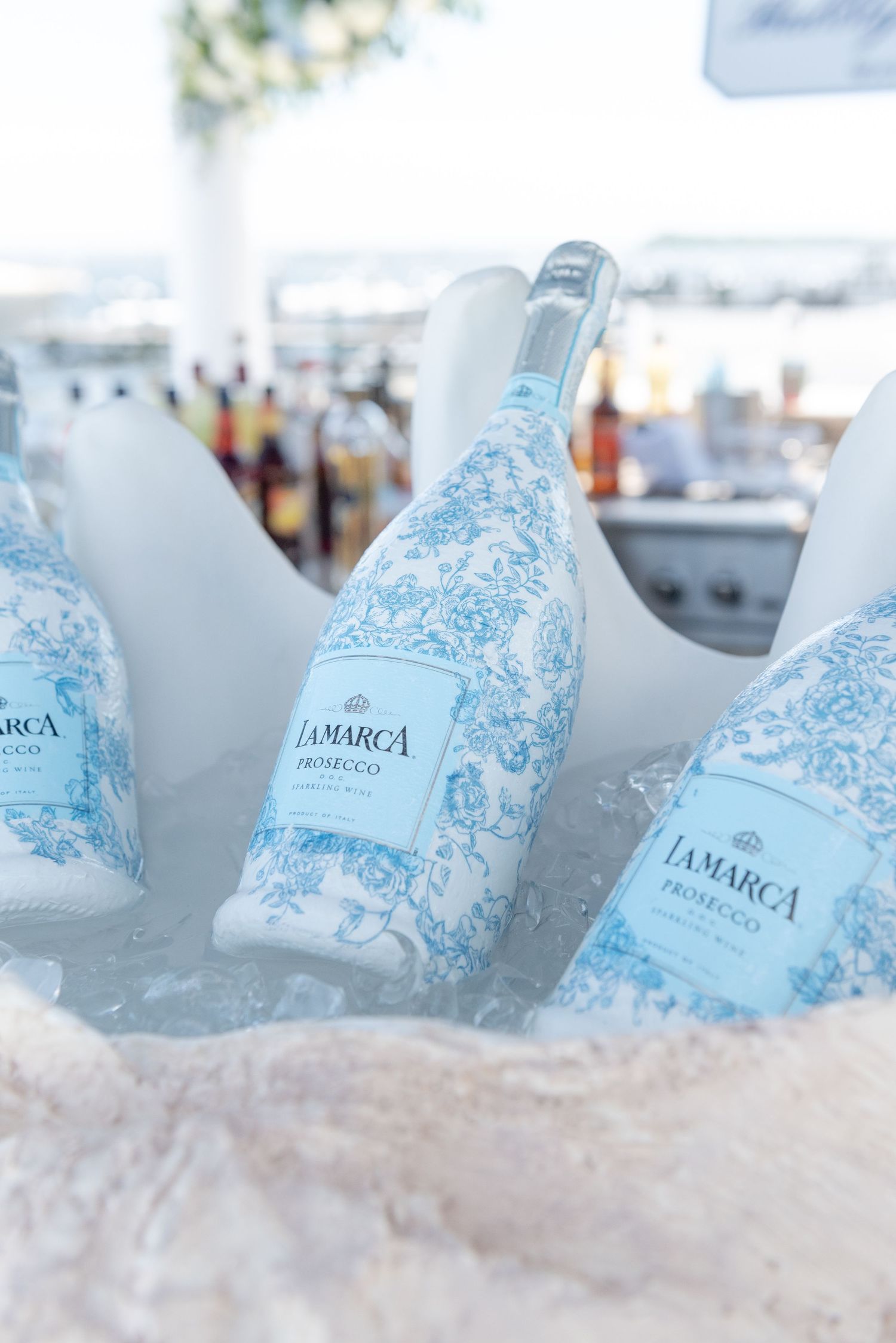 Custom champagne bottles at a bridal shower by the sea.