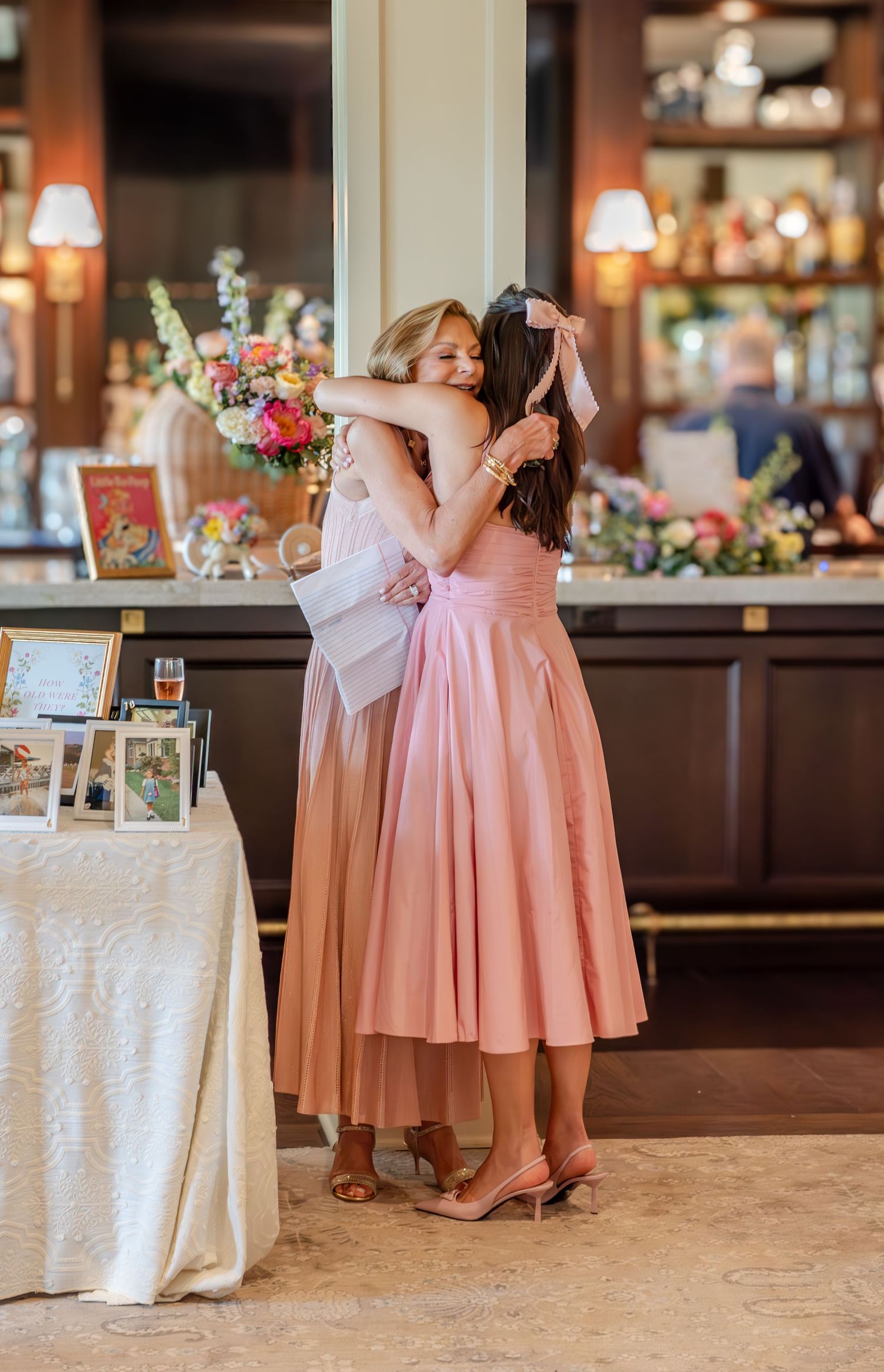 Mommy and daughter hug at a baby shower.