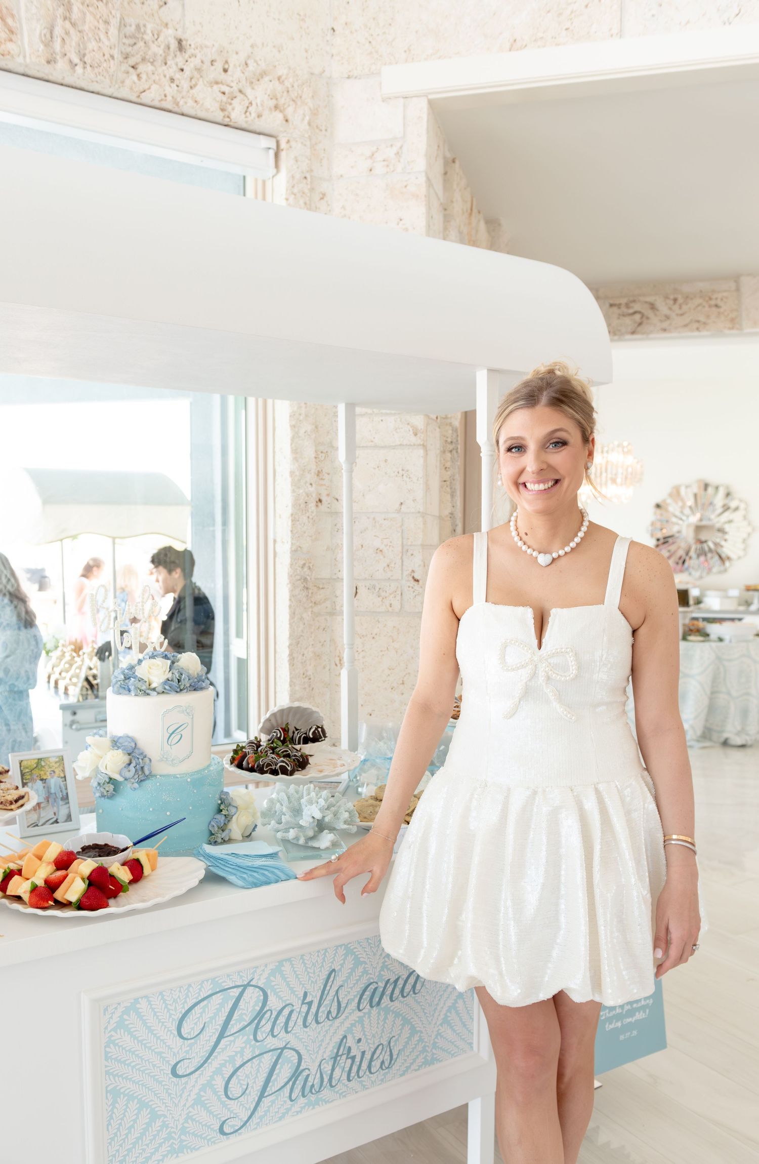 The bride-to-be in front of her cake.