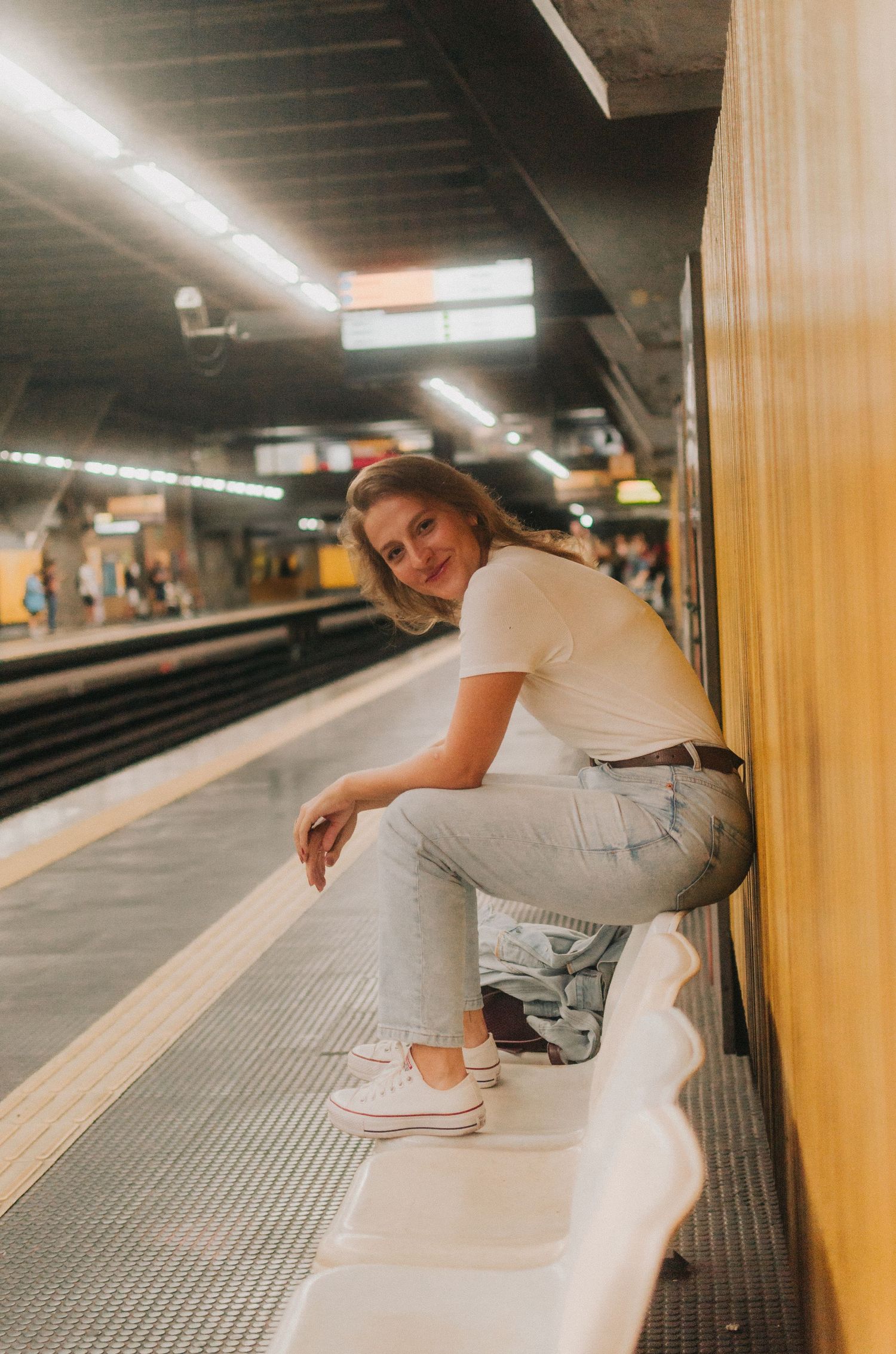 Person in white clothing performs parkour moves along a subway platform with sequential motion capture shots.