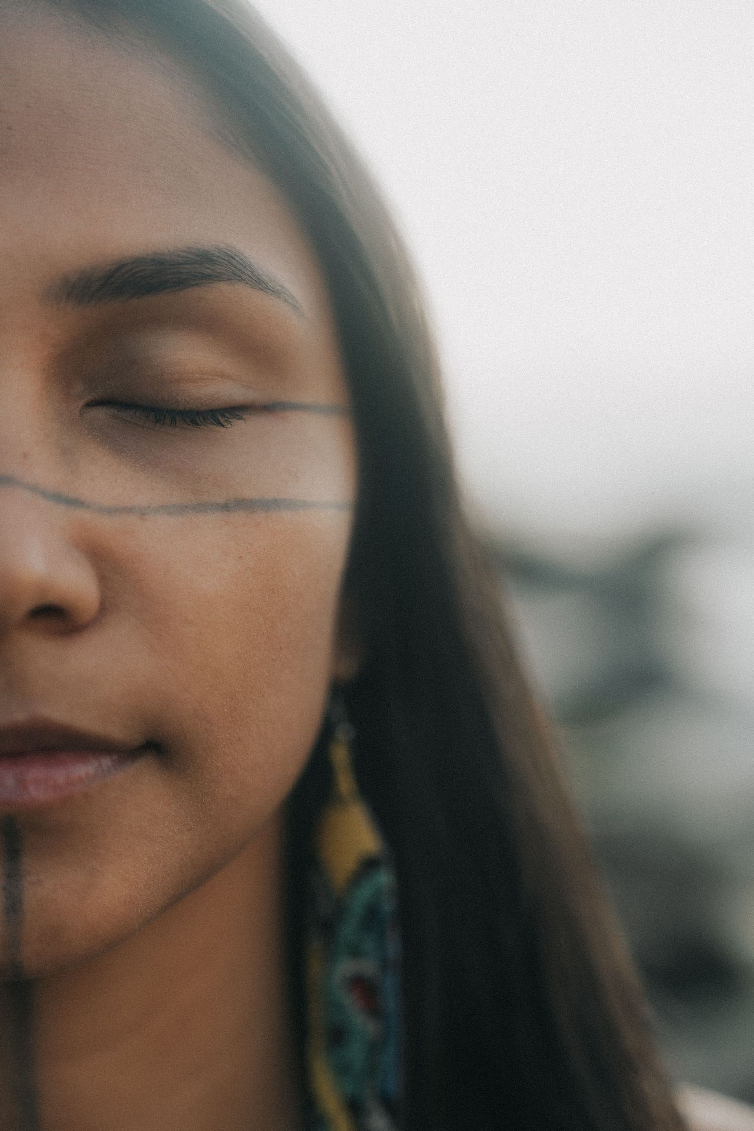 A series of artistic close-up portraits showing peaceful expressions with closed eyes and soft lighting.