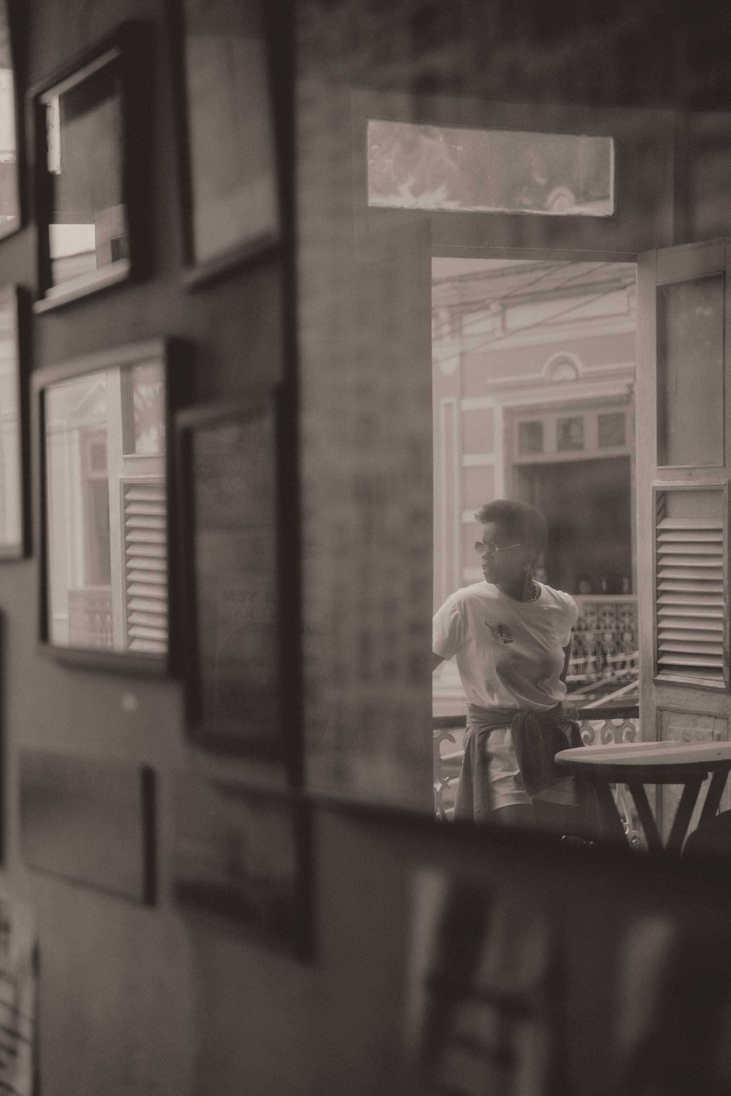 A vintage black and white sequence of interior shots showing shadowy silhouettes through frosted glass windows.
