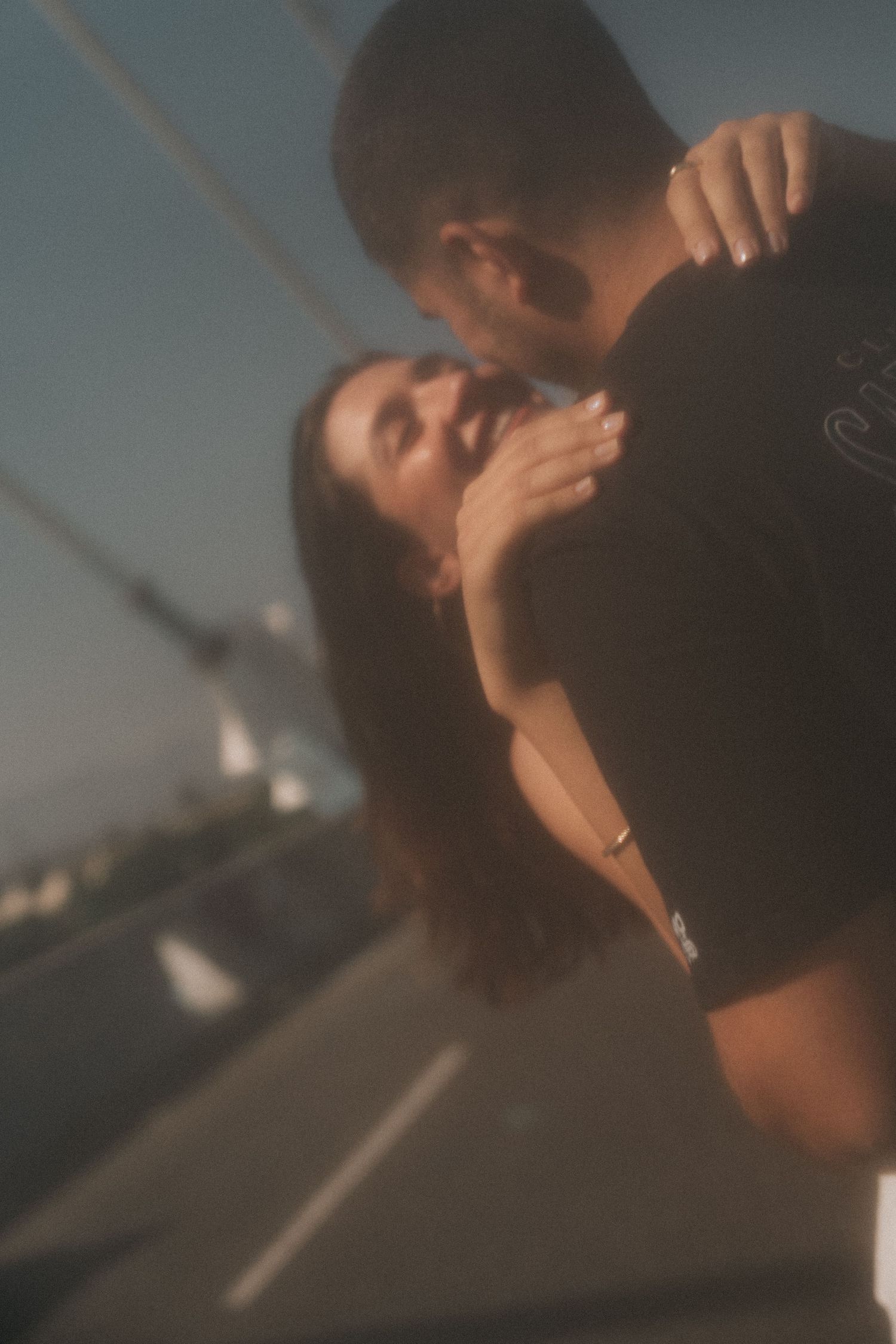 A series of warm-toned photographs show intimate moments between two people silhouetted against a soft glow.