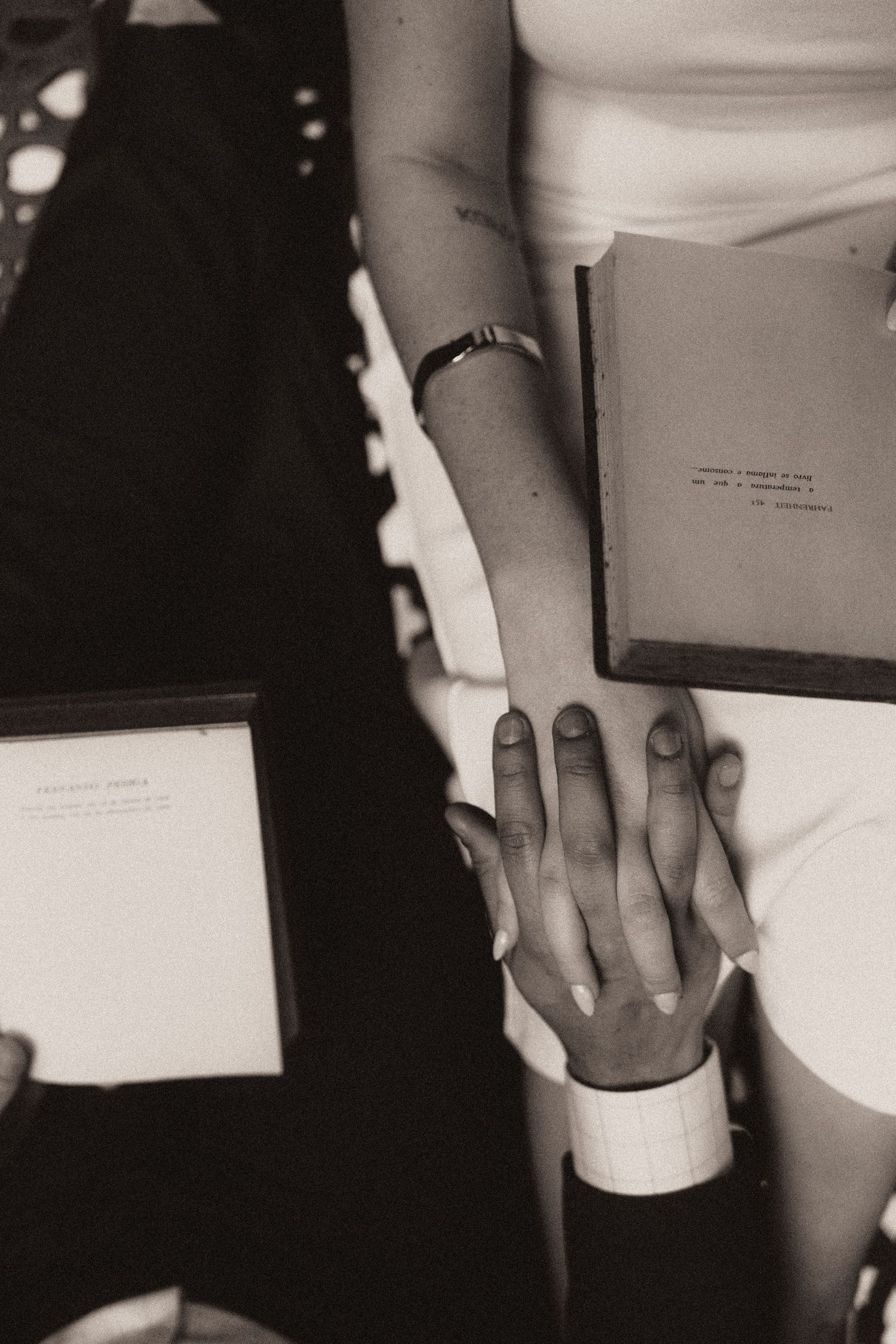 Black and white photo series showing hands holding paper documents and cups in a sequence.