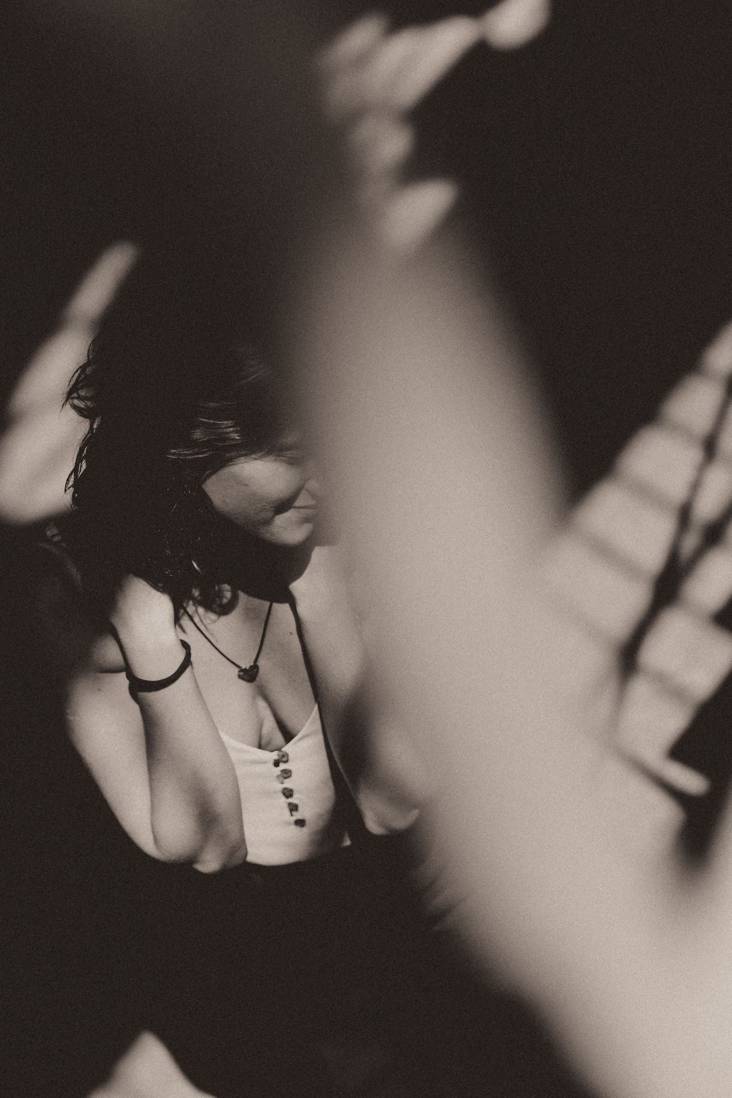 Abstract black and white artistic photo with dramatic shadows and silhouettes creating a moody atmospheric composition.