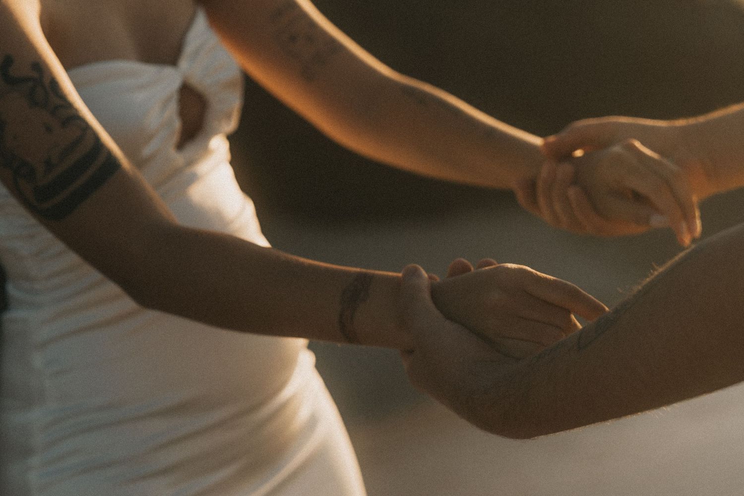 Close-up view of hands performing a therapeutic massage treatment on skin in warm lighting.