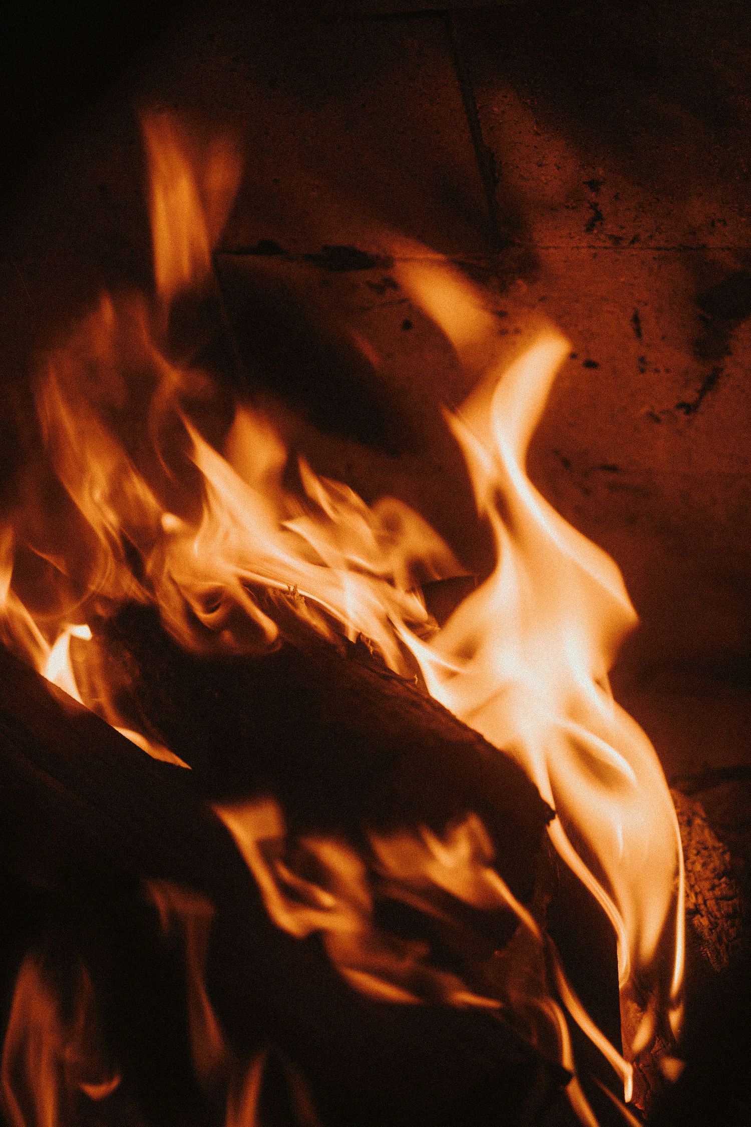Bright orange flames dance against a dark background in a sequence of close-up shots showing fire movement patterns.