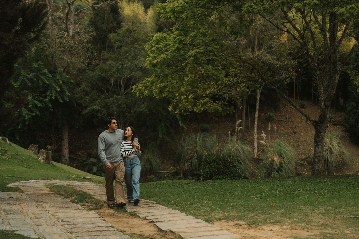 A collection of seven outdoor photographs showing people walking and enjoying nature in various park settings.