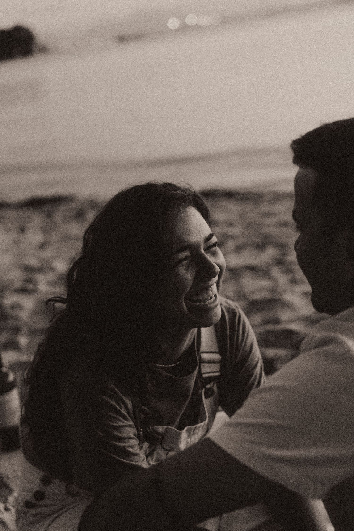 Black and white sequence showing a candid intimate moment between two people laughing and bonding together.