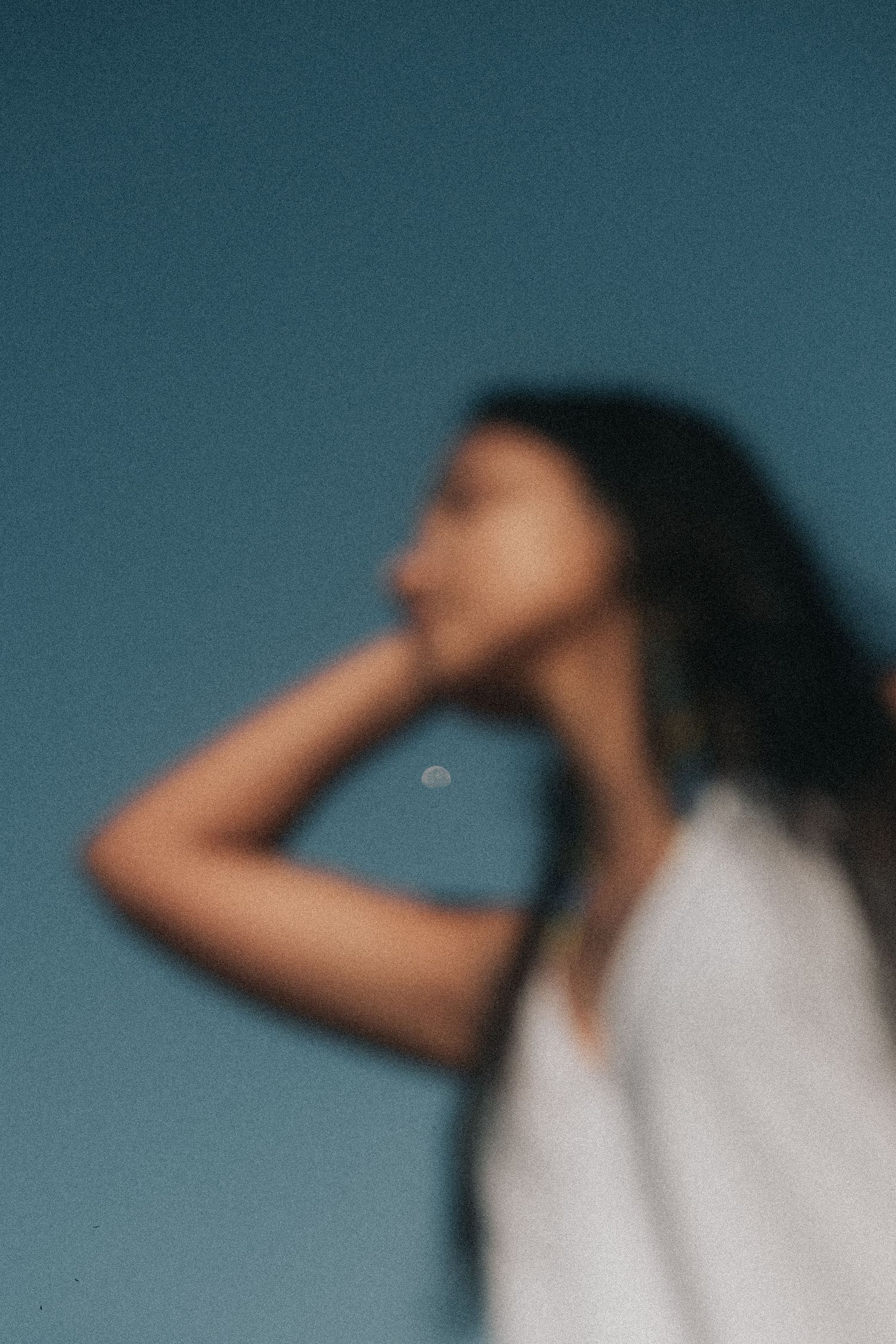 A sequence of photos showing someone in white looking away into a blue-tinted background.