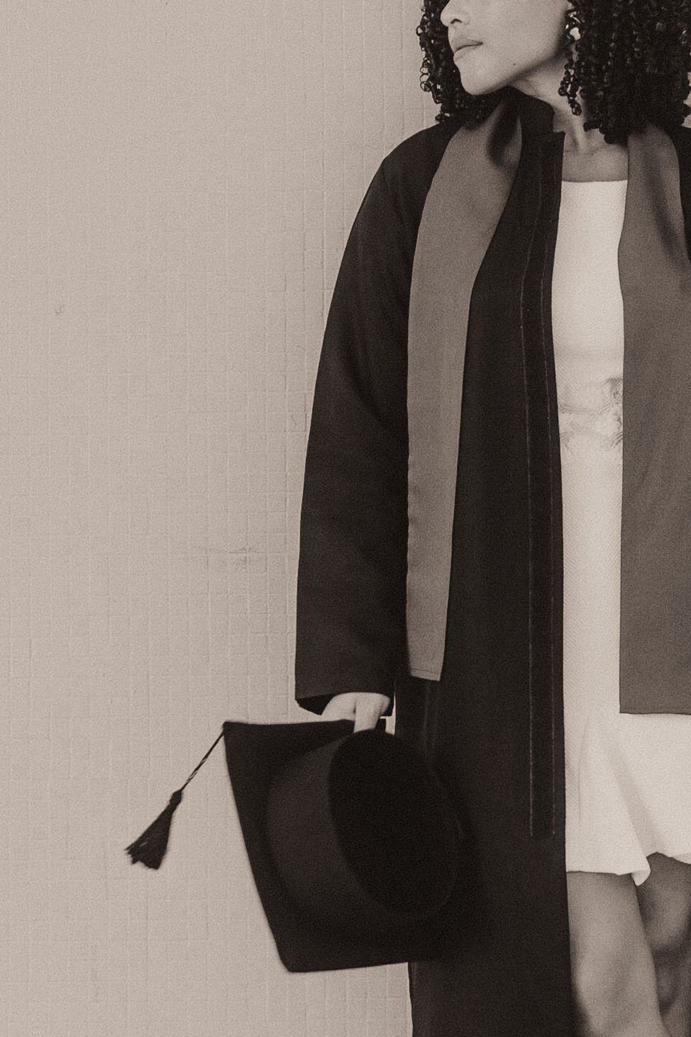 A series of black and white fashion photos showing someone wearing a black blazer with white shirt against a light background.