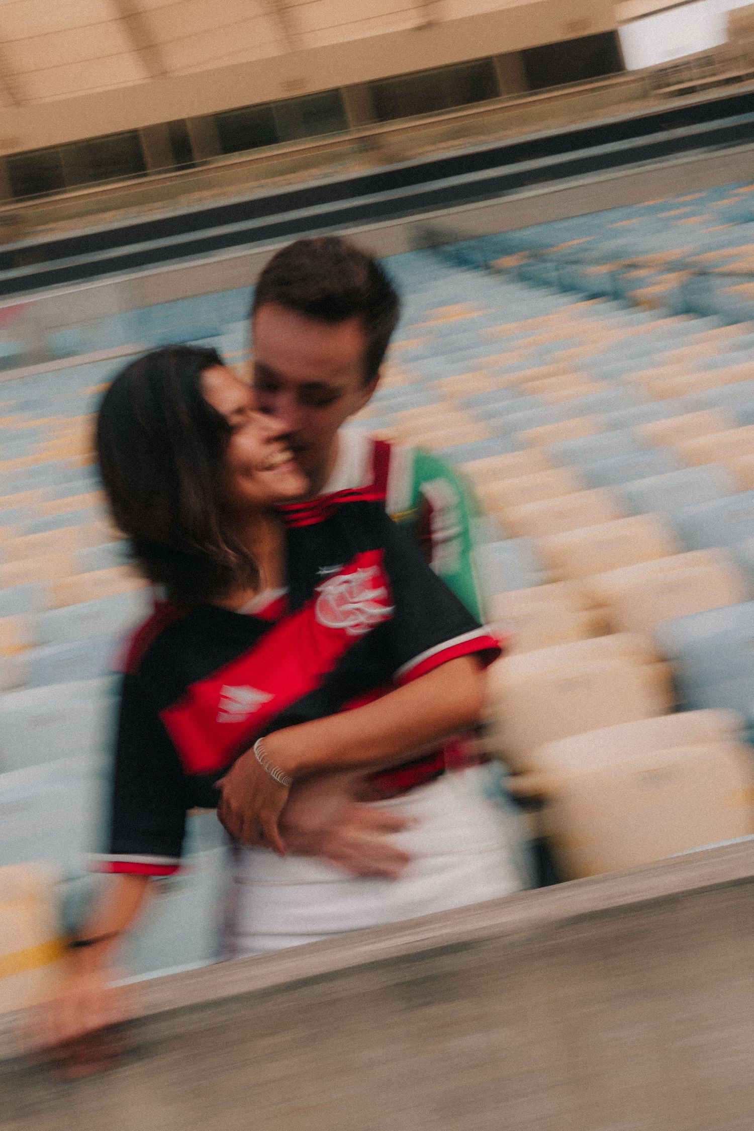A sequence of motion blur photos shows a couple in red and white embracing in what appears to be a romantic moment.