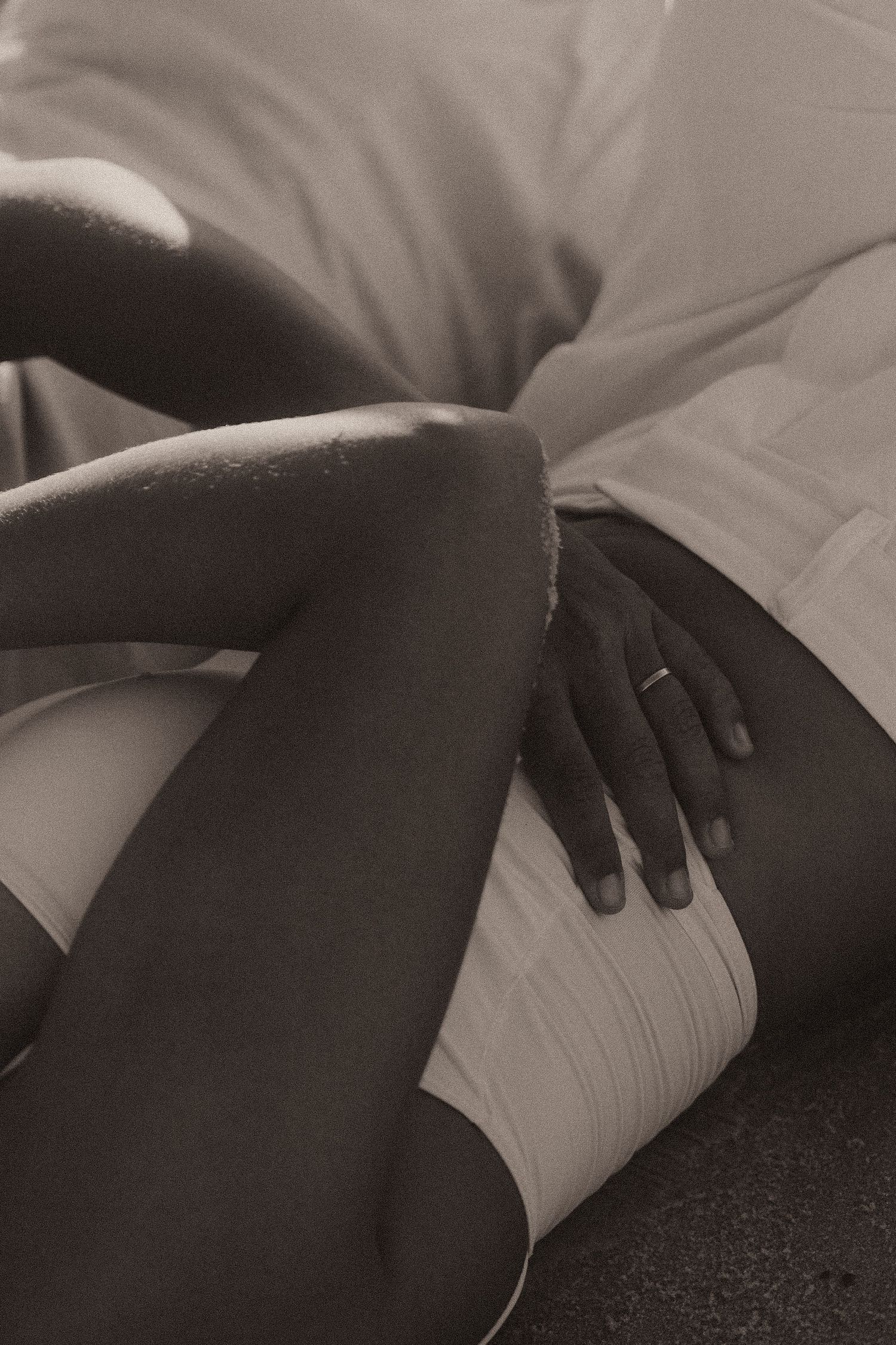 Black and white abstract close-up photographs showing cropped body parts with dark shadows and contrasting light tones.