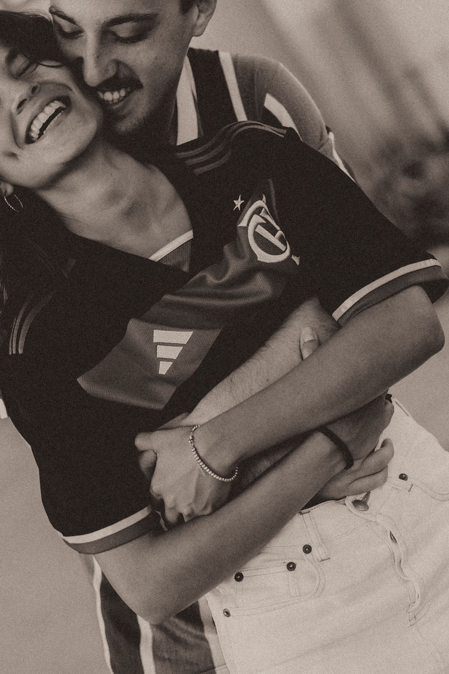 Black and white collage of affectionate romantic couple embracing and smiling in casual attire.