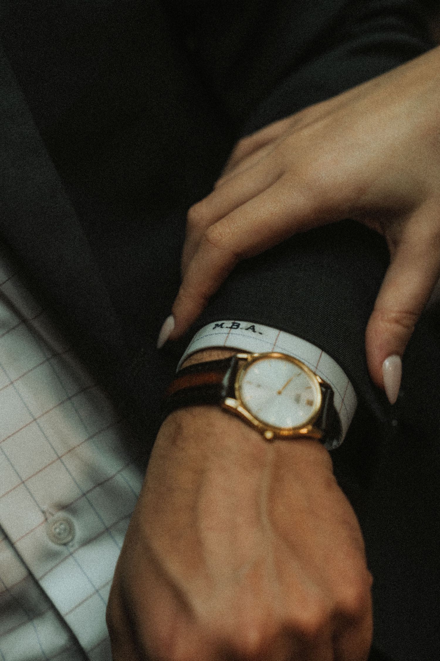 Close-up shots of hands wearing an elegant white and gold watch against a dark background.