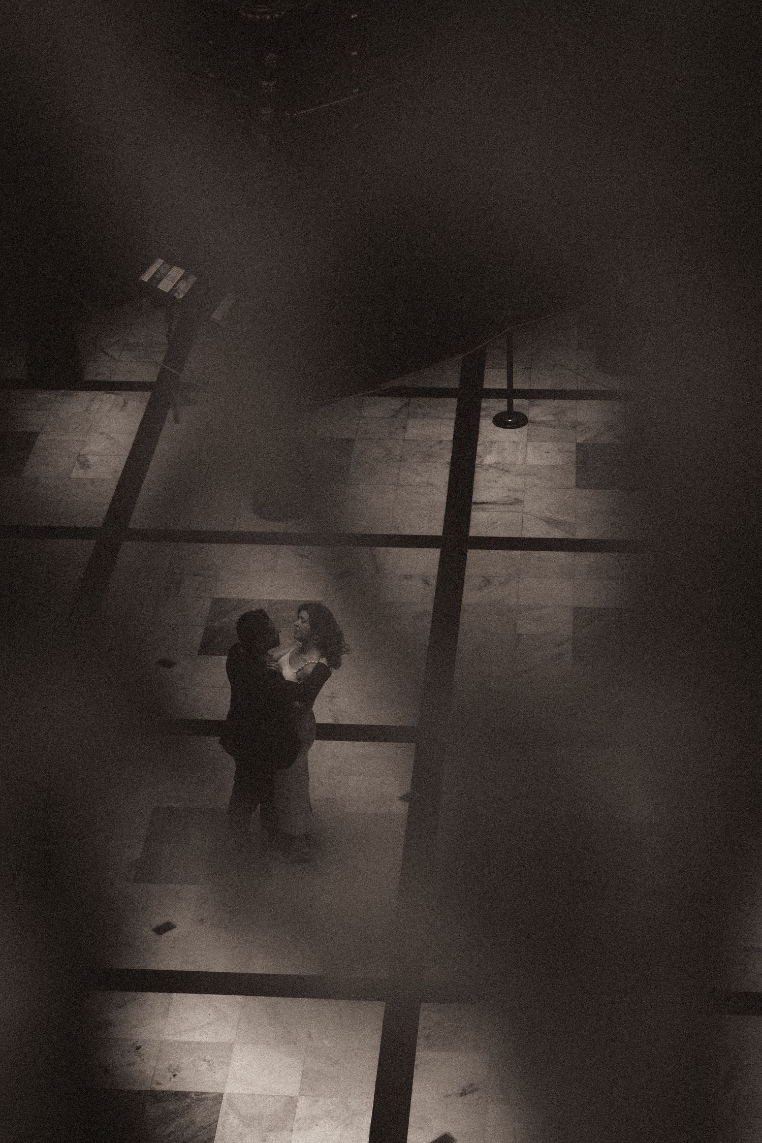 A sequence of dark aerial surveillance photos shows a figure moving across a tiled floor in low light conditions.