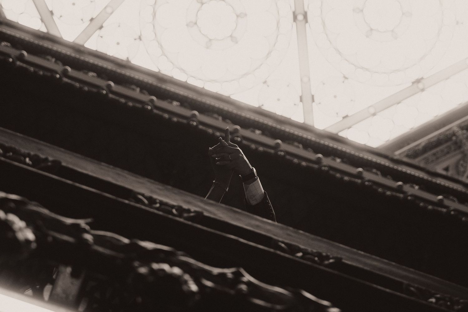 A close-up view of a damaged ceiling corner showing peeling paint and exposed plaster in deteriorating condition.