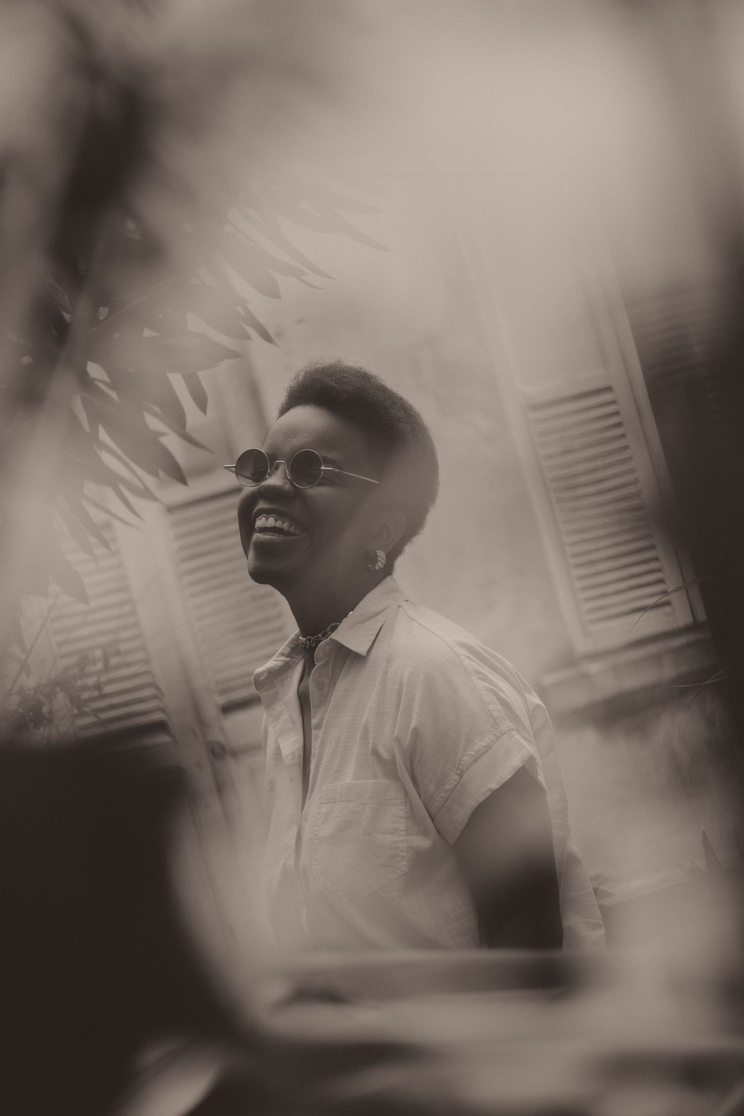 A sequence of blurry black and white photos showing someone in a white shirt expressing joyful emotions.