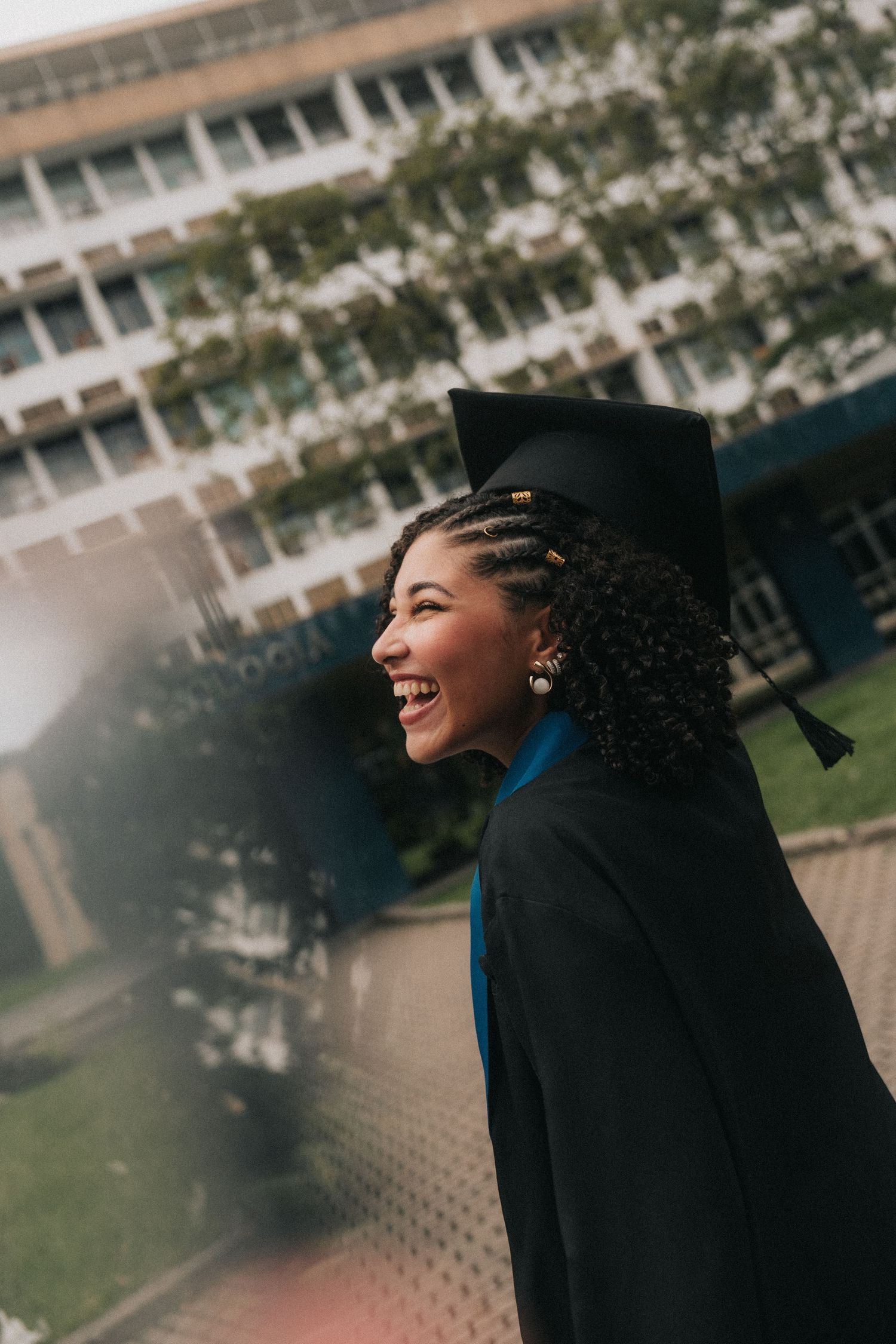 A series of profile shots shows a graduate in black cap and gown outdoors laughing joyfully during a photoshoot.