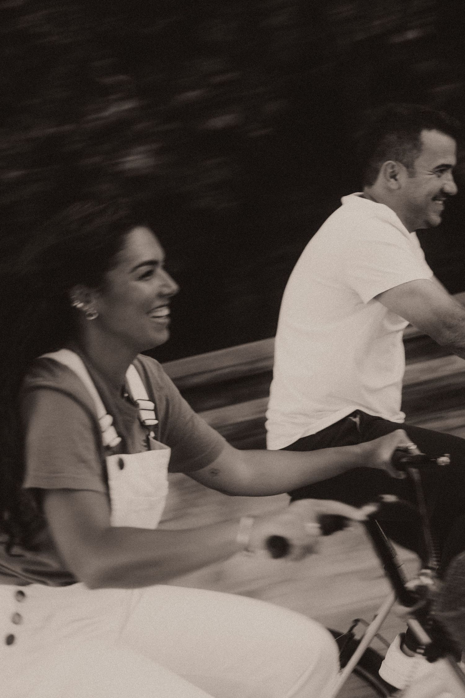 A black and white photo sequence showing a couple sharing a happy moment on a vintage car bench seat.