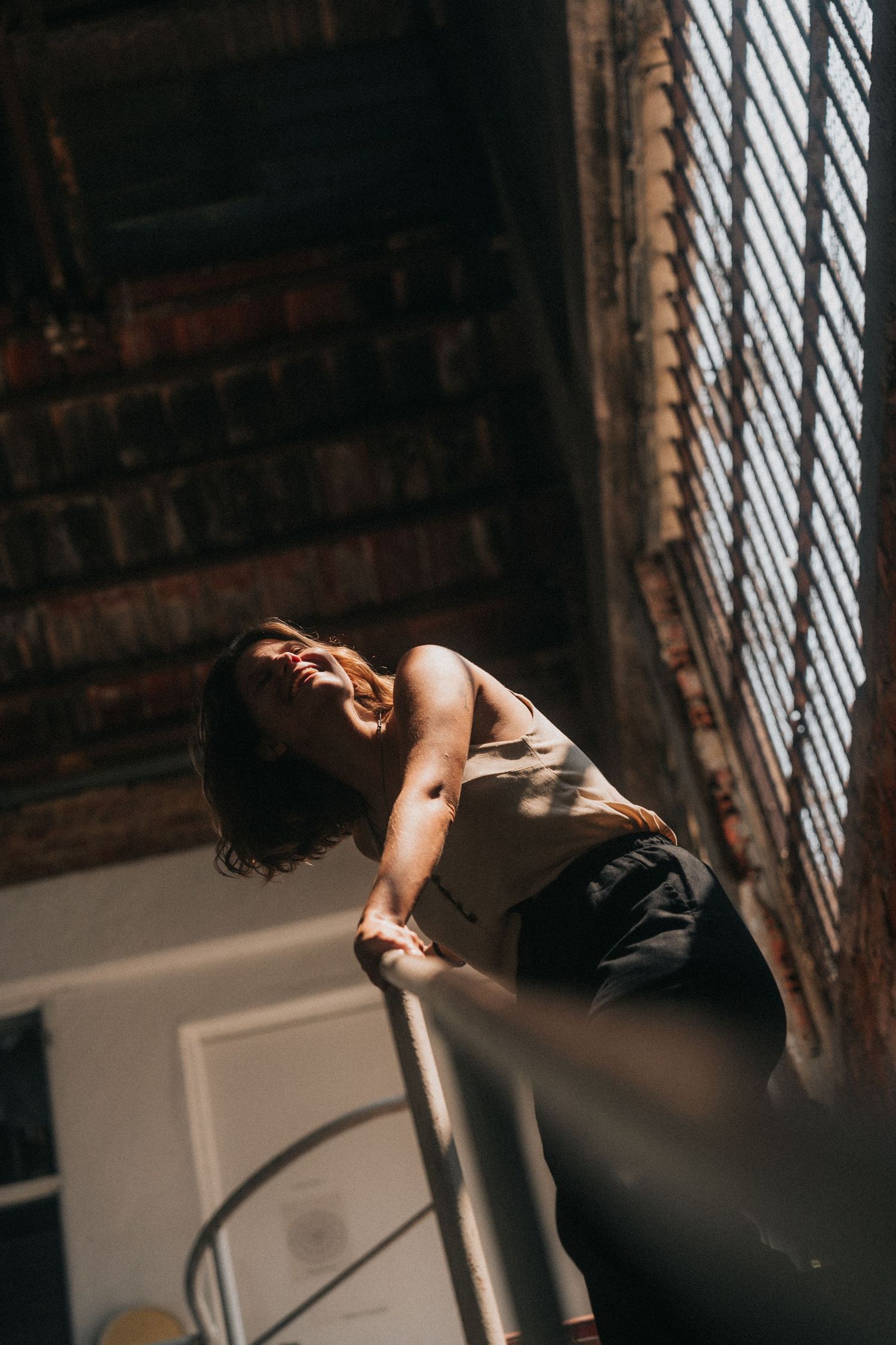 Dramatic moody series of photos showing a figure in motion against contrasting light and shadow through window blinds.