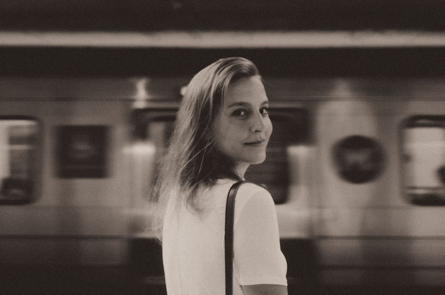 A grid of black and white vintage photography shots showing blurred urban subway scenes.